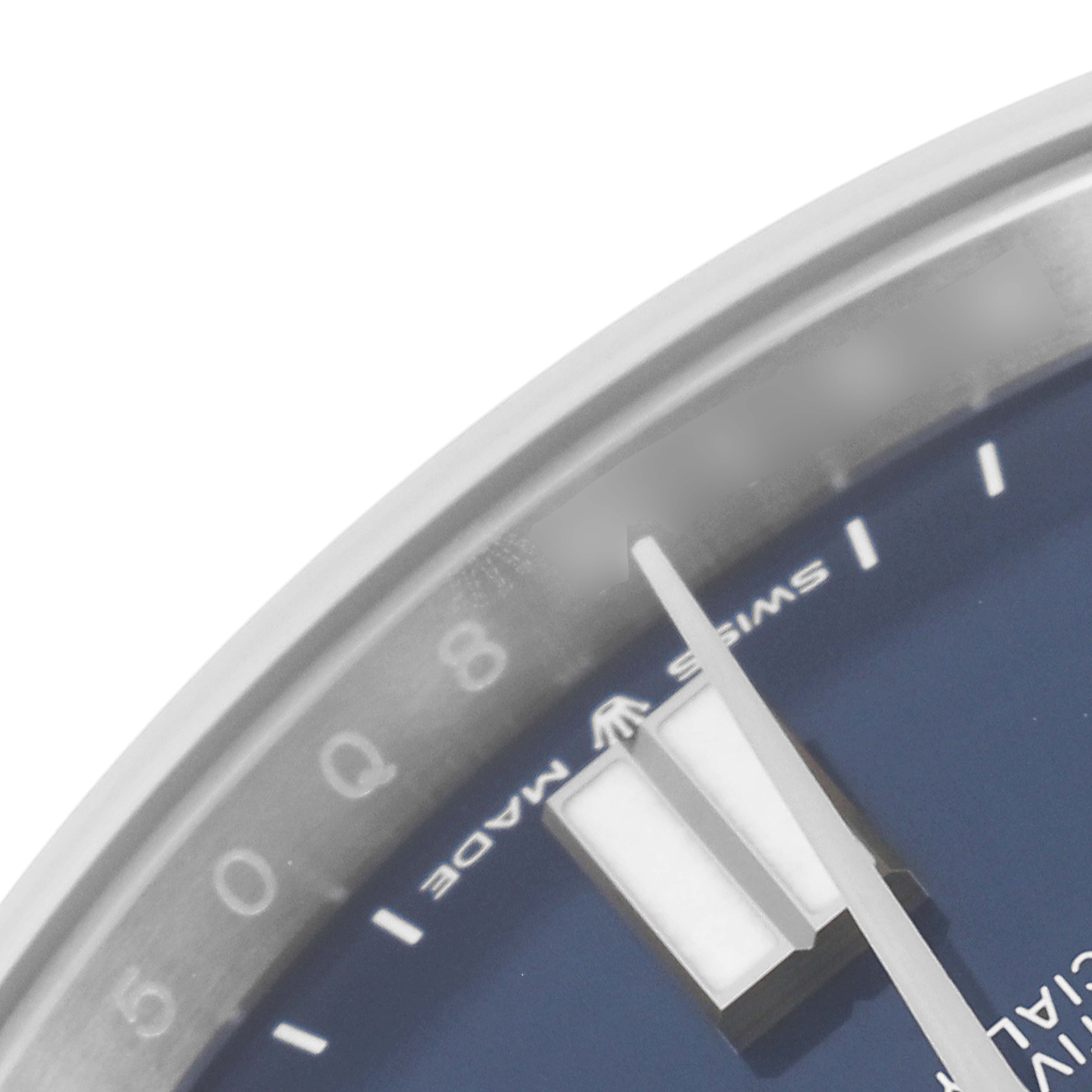 The image shows a close-up of the dial edge, including markers and hands, of a Rolex Oyster Perpetual 124300 Men
s Stainless Steel Blue Dial 124300 Men
s Stainless Steel Blue Dial watch model.