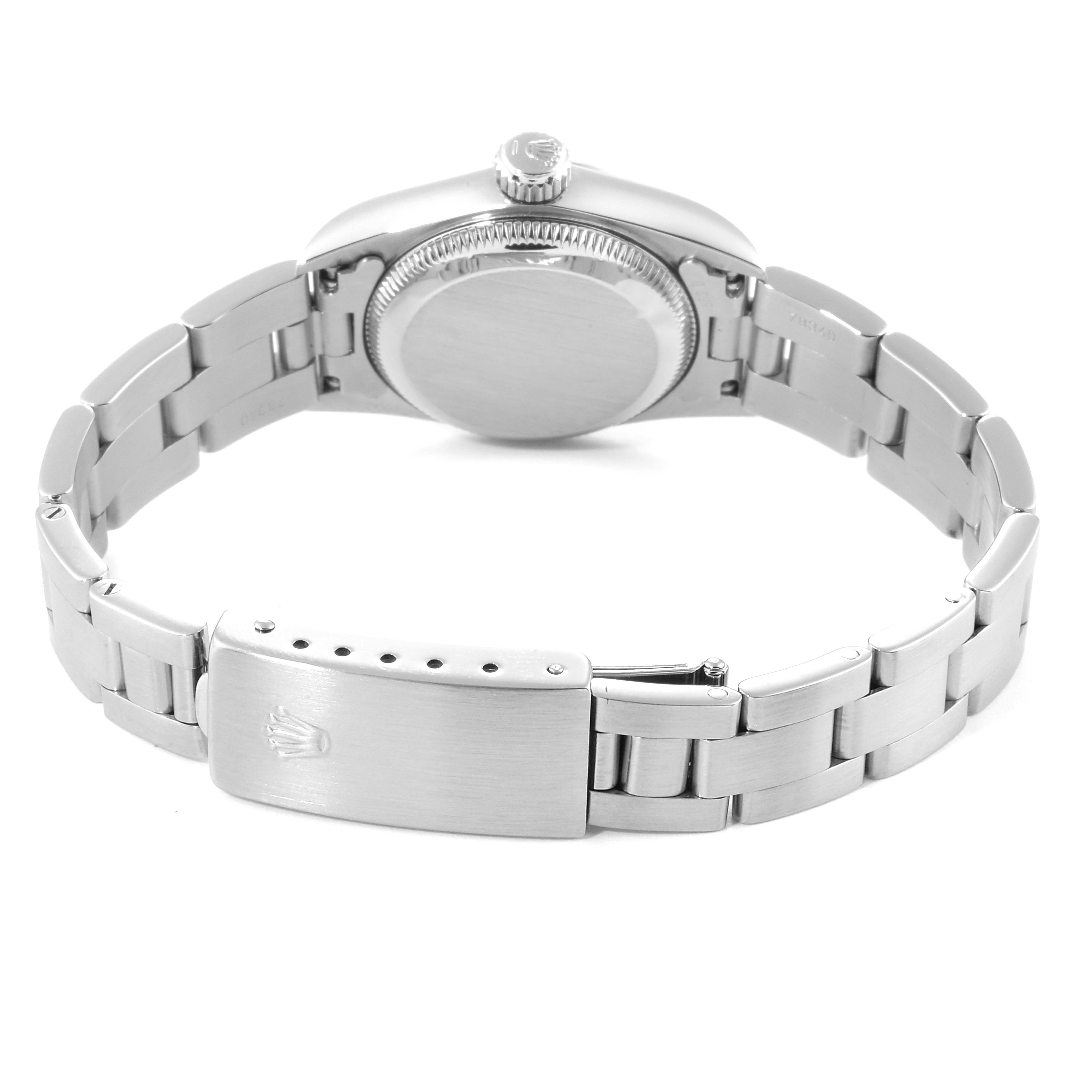 The image shows the back view of a Rolex Oyster Perpetual 67180 Women
s Stainless Steel Black Dial 67180 Women
s Stainless Steel Black Dial watch, highlighting its closed case back and stainless steel bracelet with a clasp.