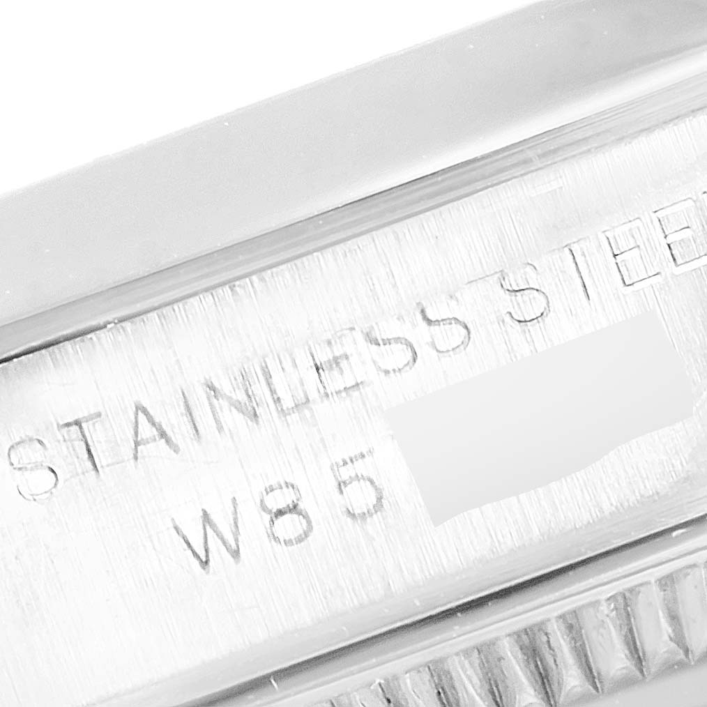 This close-up image of a Rolex Oyster Perpetual 67180 Women
s Stainless Steel Black Dial 67180 Women
s Stainless Steel Black Dial watch shows the side of the stainless steel case with engraved markings.