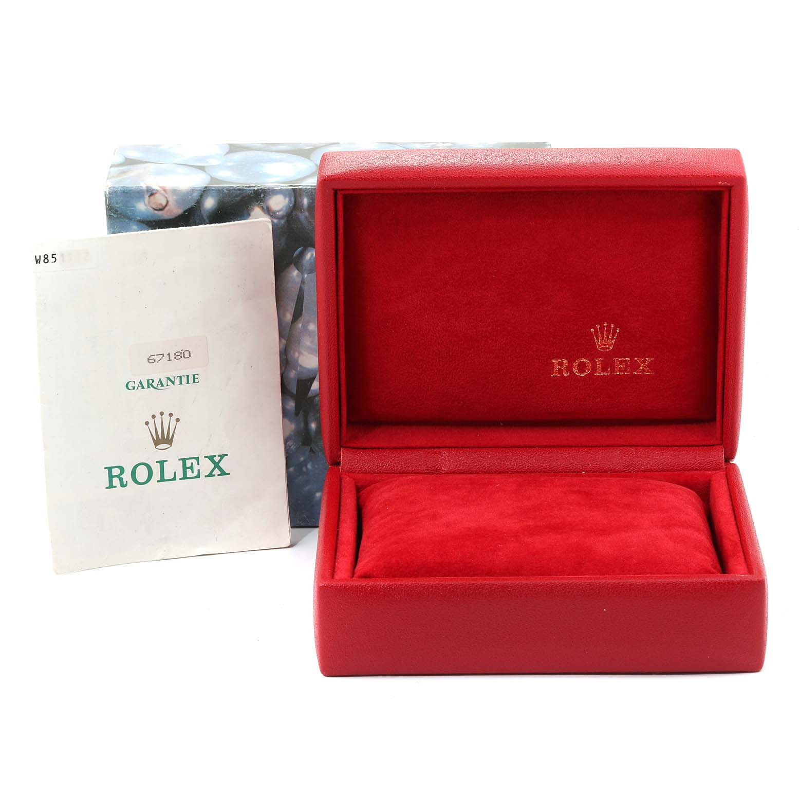 The image shows an empty red Rolex watch box for the Oyster Perpetual model and a guarantee booklet.