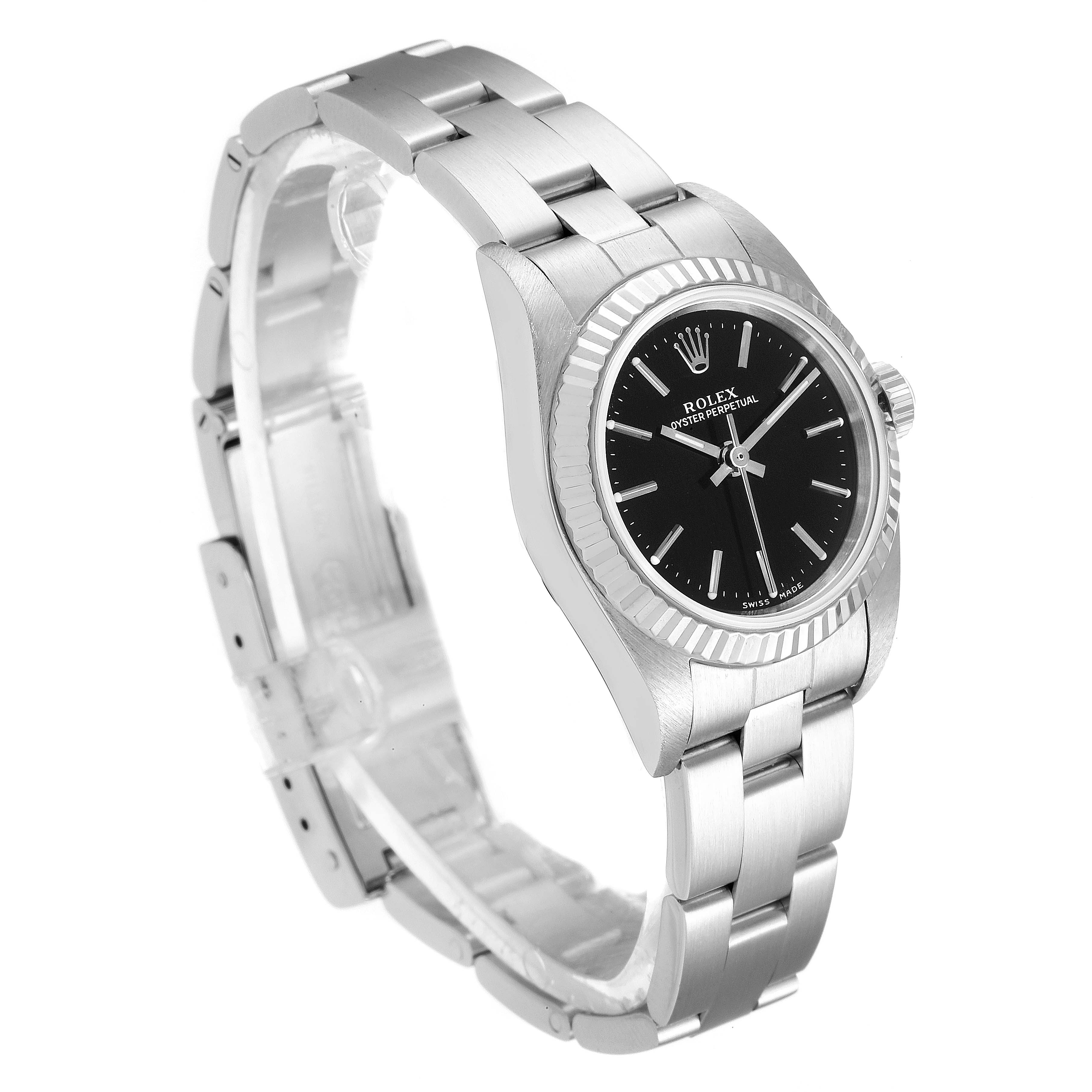 This image shows a Rolex Oyster Perpetual 76094 Women's Stainless Steel Black Dial 76094 Women's Stainless Steel Black Dial watch from an angled side view, featuring its face, bezel, and partially open bracelet.