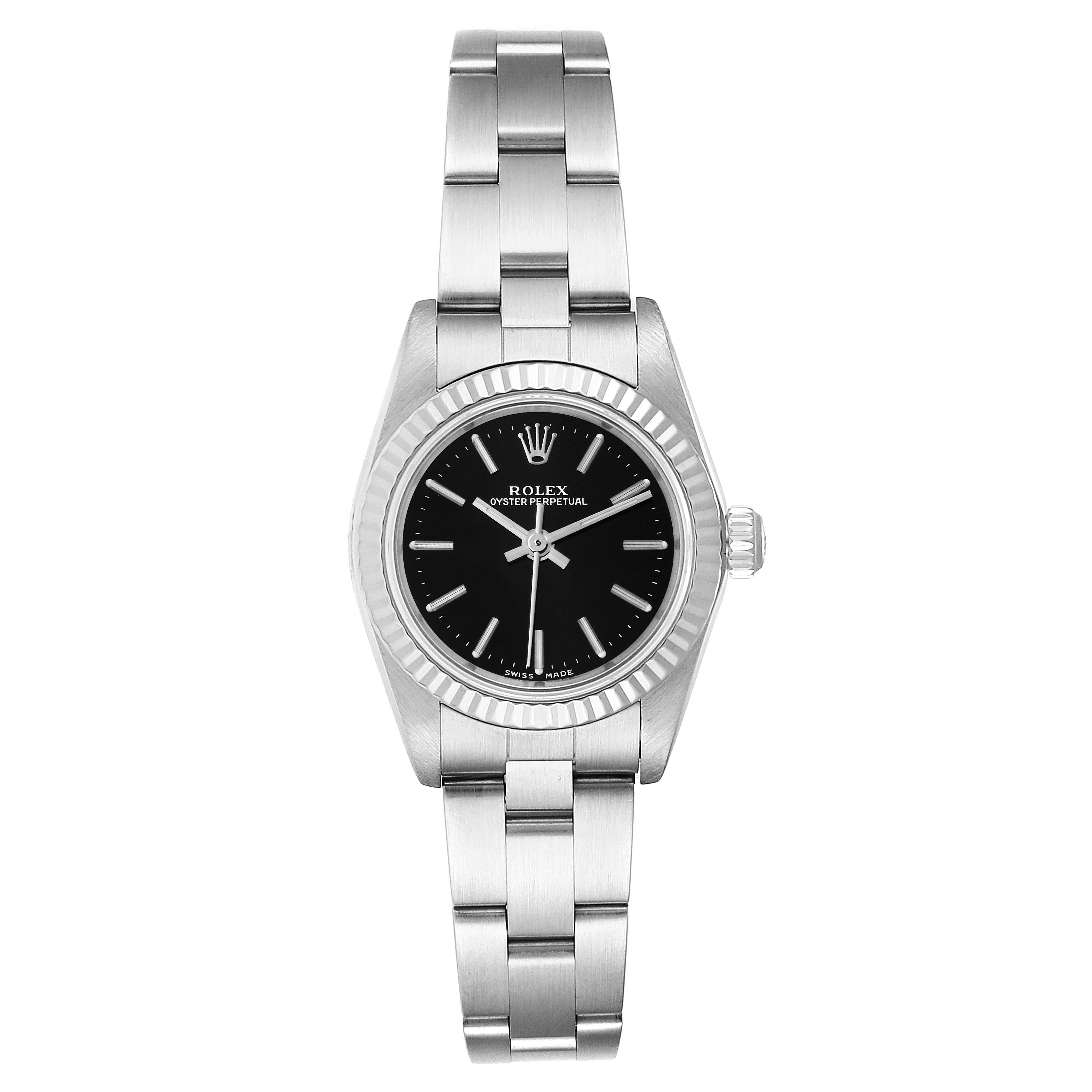 The image shows a front view of a Rolex Oyster Perpetual 76094 Women's Stainless Steel Black Dial 76094 Women's Stainless Steel Black Dial watch showcasing its black dial, fluted bezel, and stainless steel bracelet.