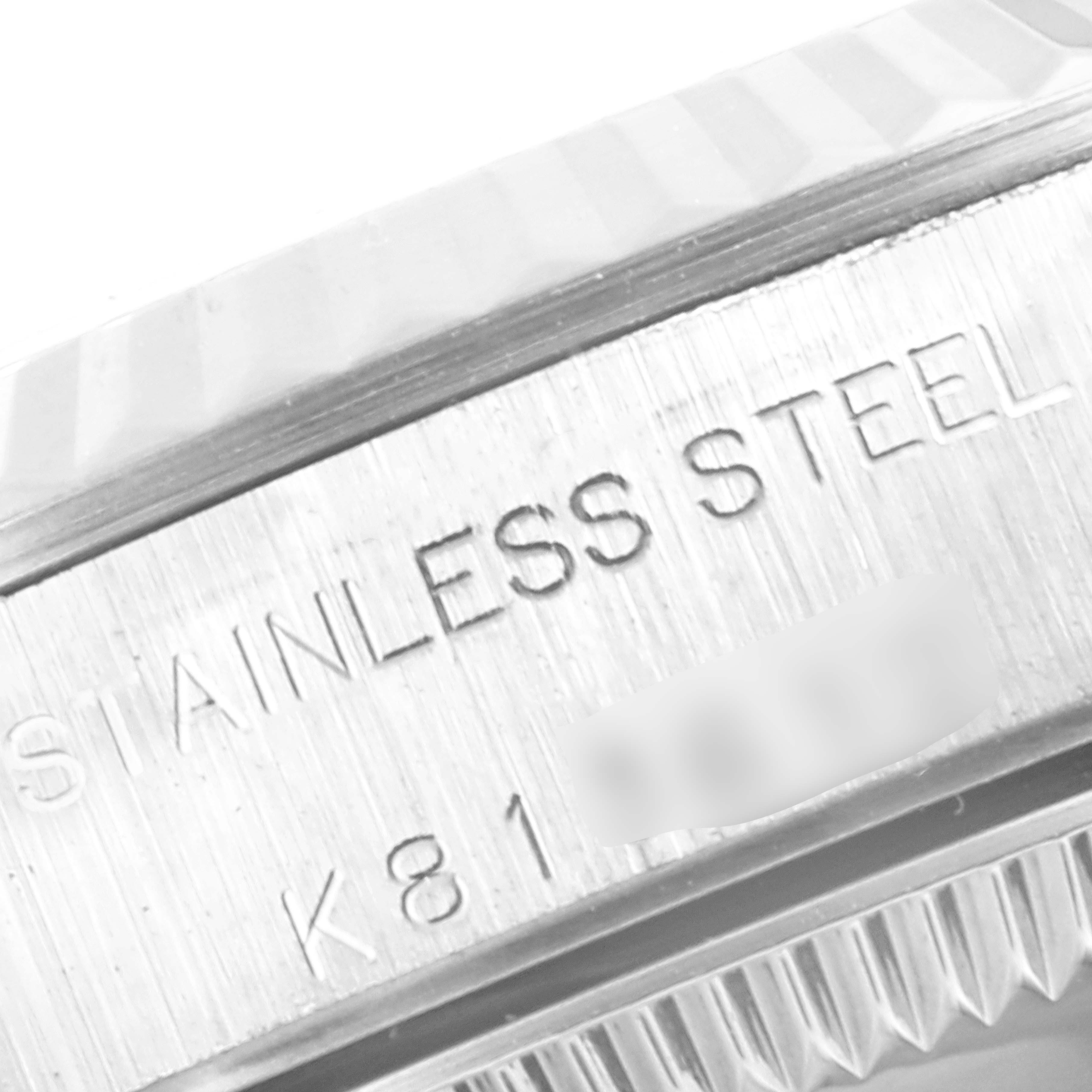 This close-up image of a Rolex Oyster Perpetual 76094 Women's Stainless Steel Black Dial 76094 Women's Stainless Steel Black Dial shows the side of its stainless steel case, featuring the "STAINLESS STEEL" engraving.