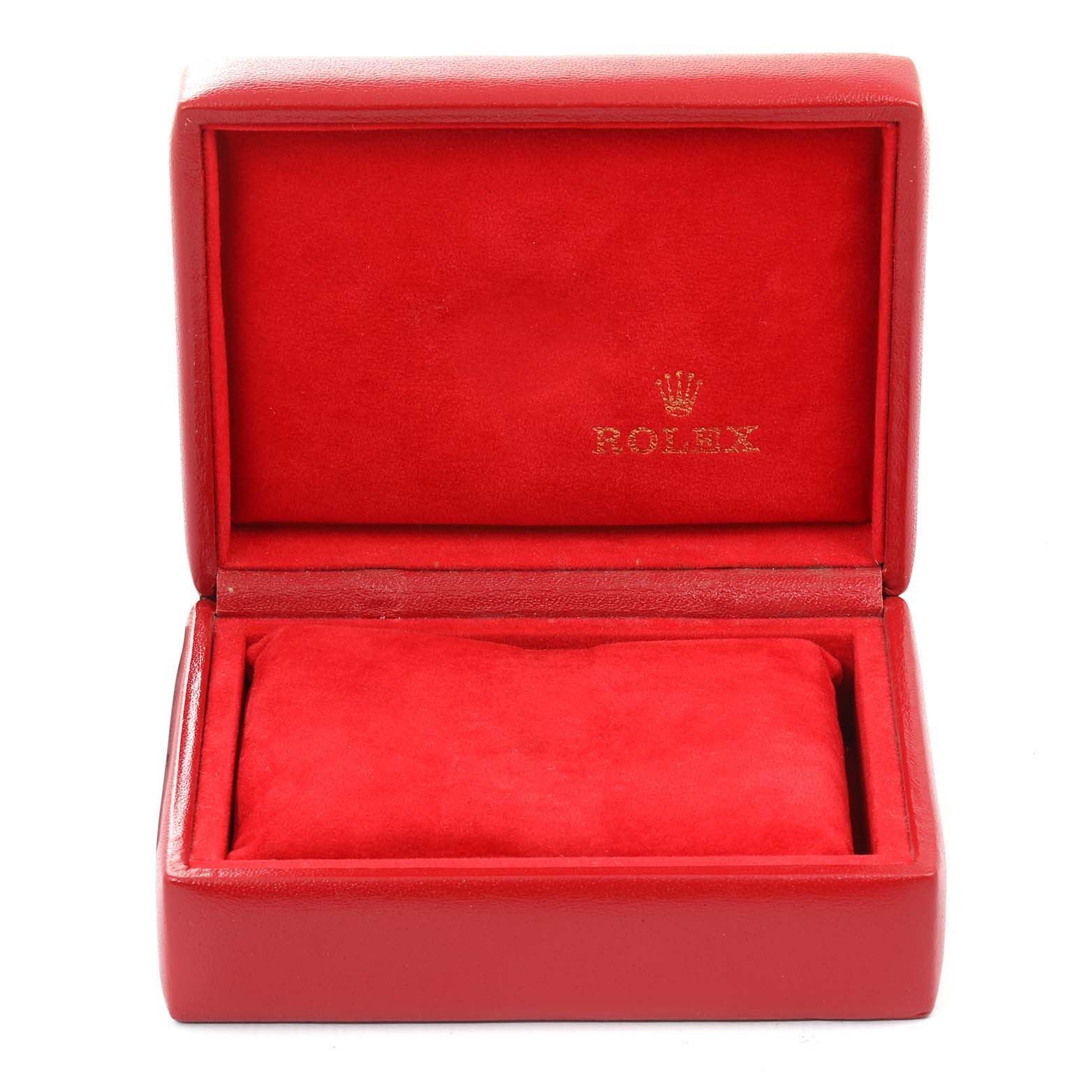 The image shows an open red Rolex case for an Oyster Perpetual model, with a pillow inside for the watch.