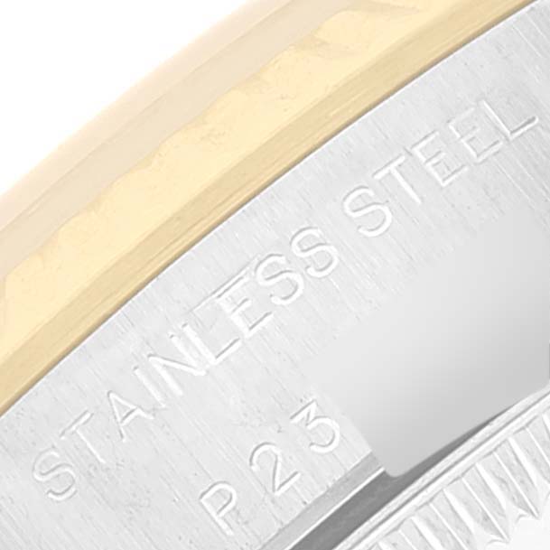 This close-up image shows part of the stainless steel case of a Rolex Oyster Perpetual 76193 Women's Steel and Gold (two tone) White Dial 76193 Women's Steel and Gold (two tone) White Dial, highlighting markings and the bezel.