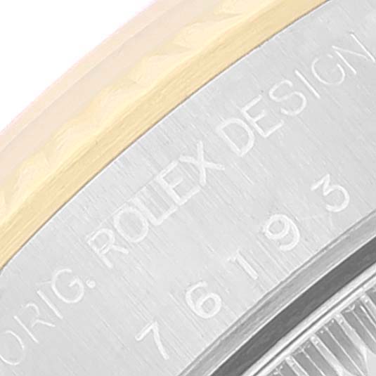The image shows a close-up of the engravings on the rim of a Rolex Oyster Perpetual 76193 Women's Steel and Gold (two tone) White Dial 76193 Women's Steel and Gold (two tone) White Dial watch.