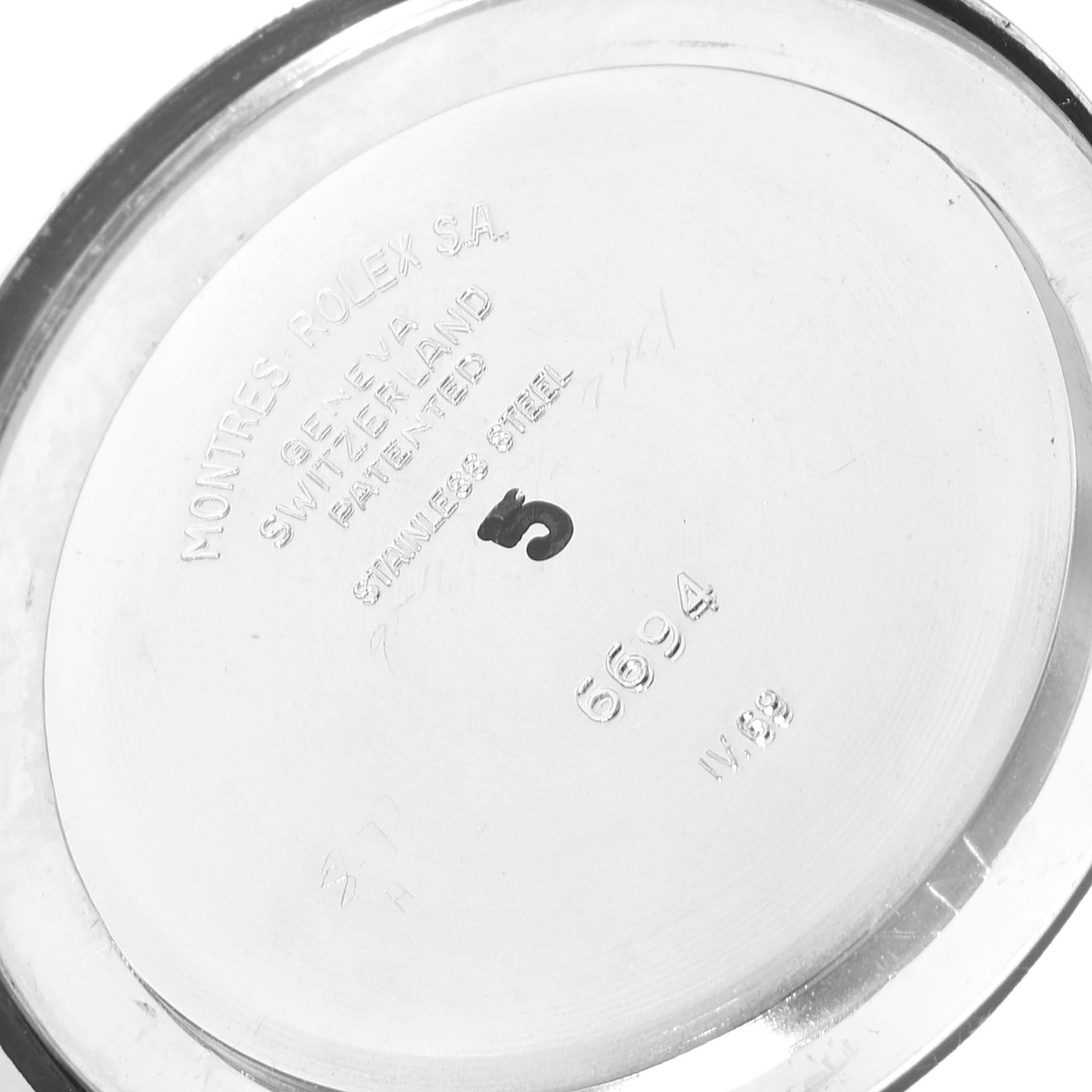 This is the back casing of a Rolex Vintage Collection 6694 Men
s Stainless Steel Black Dial 6694 Men
s Stainless Steel Black Dial watch with engraved details visible.