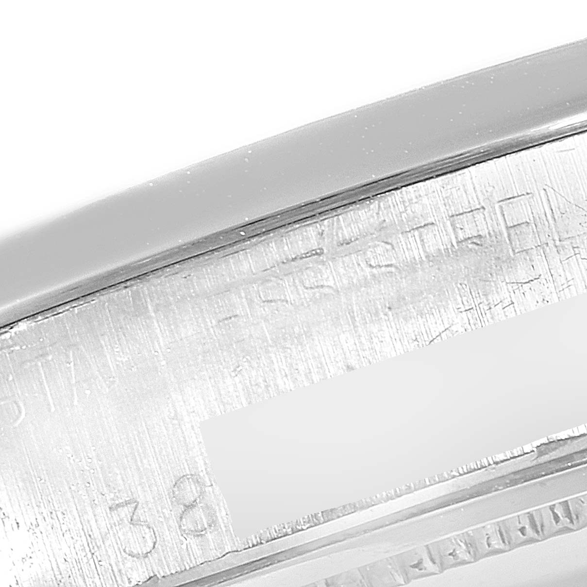 The image shows a close-up of the side engraving on the case of a Vintage Collection model by Rolex.