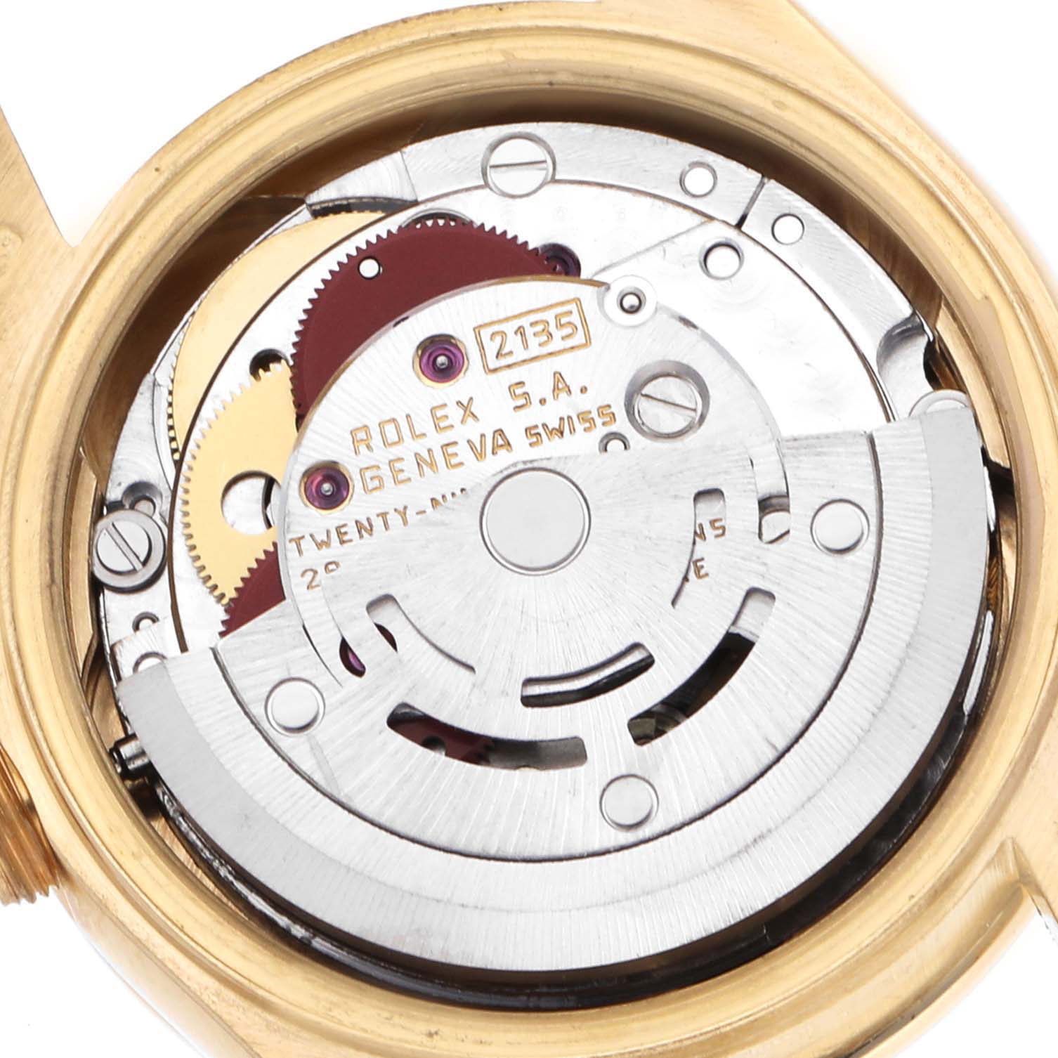 The image shows the inner movement mechanism of the Rolex President 69138 Women's Yellow Gold Champagne Dial, highlighting gears and engravings.