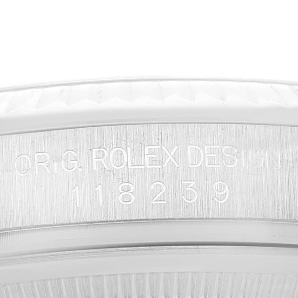 The image shows a close-up of the side of a Rolex President 118239 Men's White Gold Silver Dial 118239 Men's White Gold Silver Dial model's case with the serial number and inscription visible.