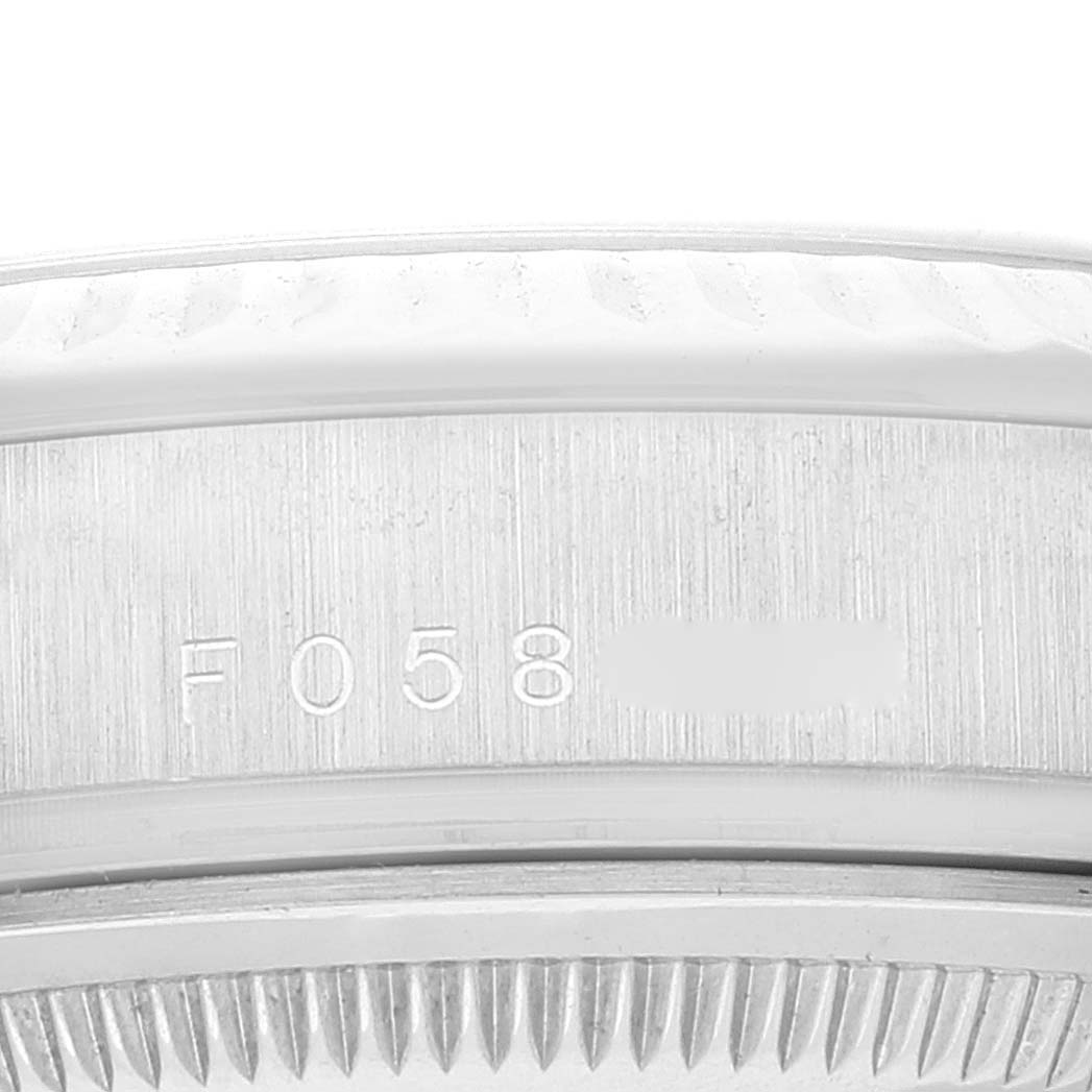 This image shows a close-up view of the side of the case of a Rolex President 118239 Men's White Gold Silver Dial 118239 Men's White Gold Silver Dial model, highlighting the serial and model numbers.