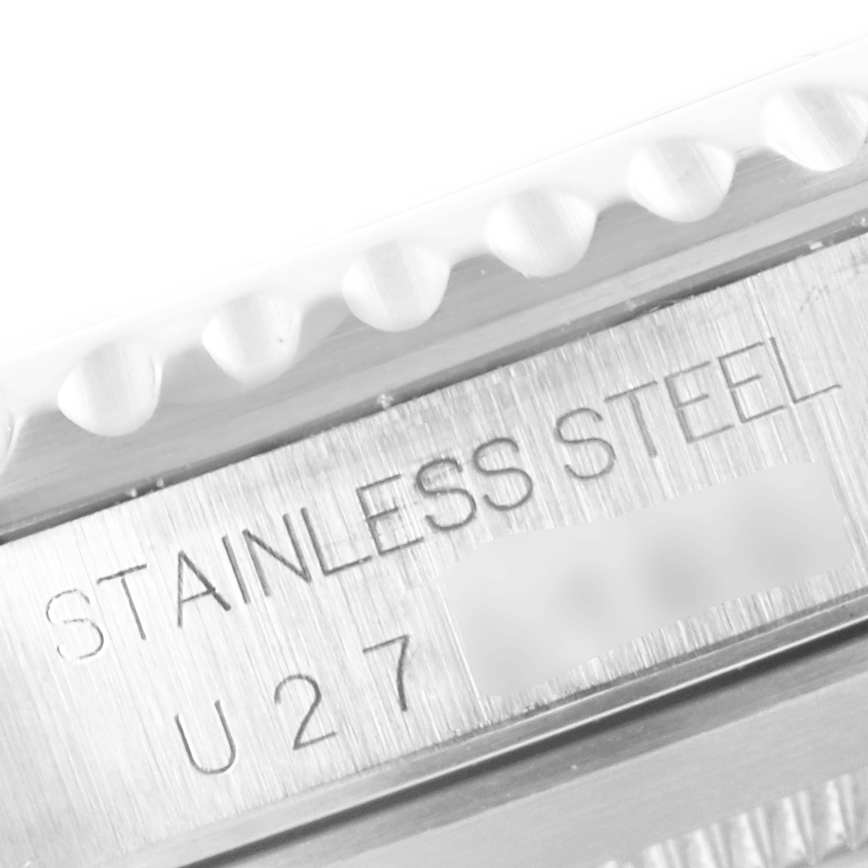 The image shows a close-up of the engraved serial number and material type on the case back of a Rolex Submariner 14060 Men's Stainless Steel Black Dial 14060 Men's Stainless Steel Black Dial.