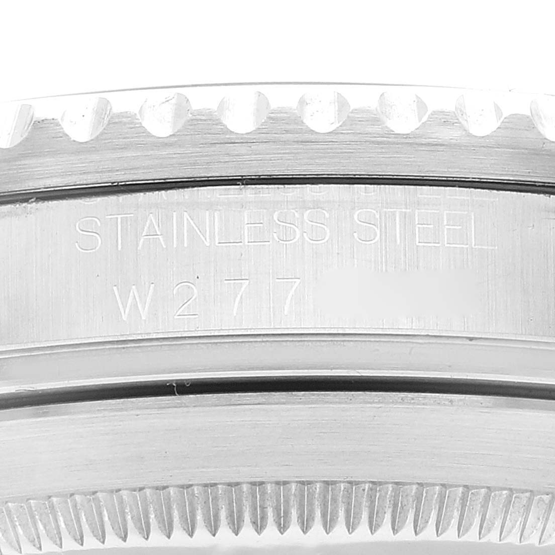 This is a close-up of the side and the bezel of a Rolex Submariner 16610 Men
s Stainless Steel Black Dial 16610 Men
s Stainless Steel Black Dial, showing engraved text and the serrated edge.