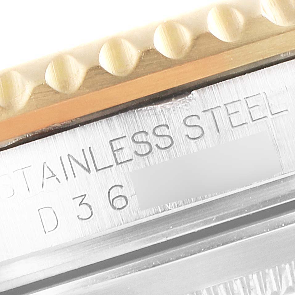 The image shows a close-up of the bezel and case, highlighting the "STAINLESS STEEL" engraving on the Rolex Submariner 16613 Men's Steel and Gold (two tone) Black Dial 16613 Men's Steel and Gold (two tone) Black Dial model.