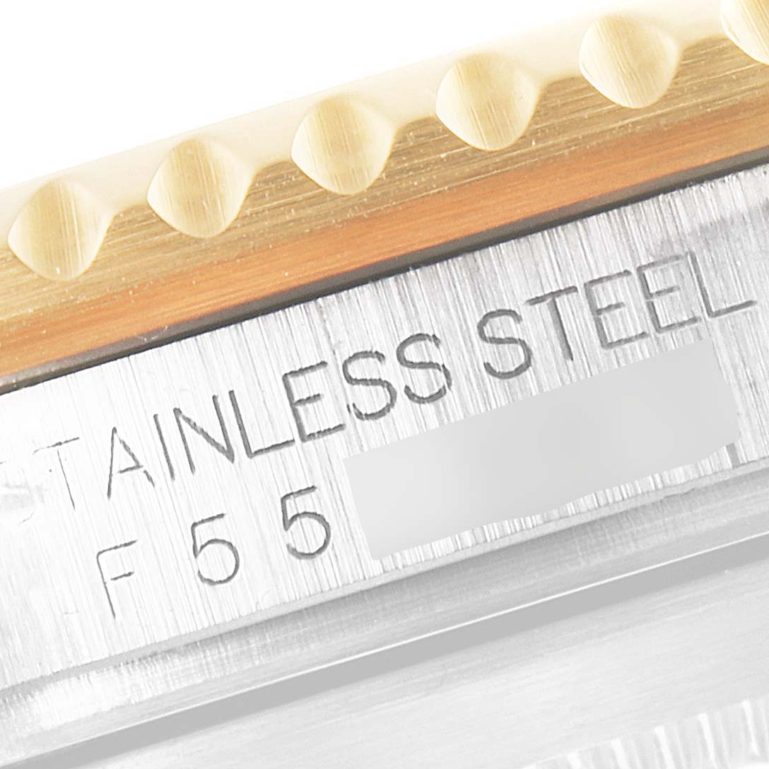 The image shows a close-up of the case and bezel of a Rolex Submariner 16613 Men
s Steel and Gold (two tone) Blue Dial 16613 Men
s Steel and Gold (two tone) Blue Dial, highlighting the stainless steel engraving.