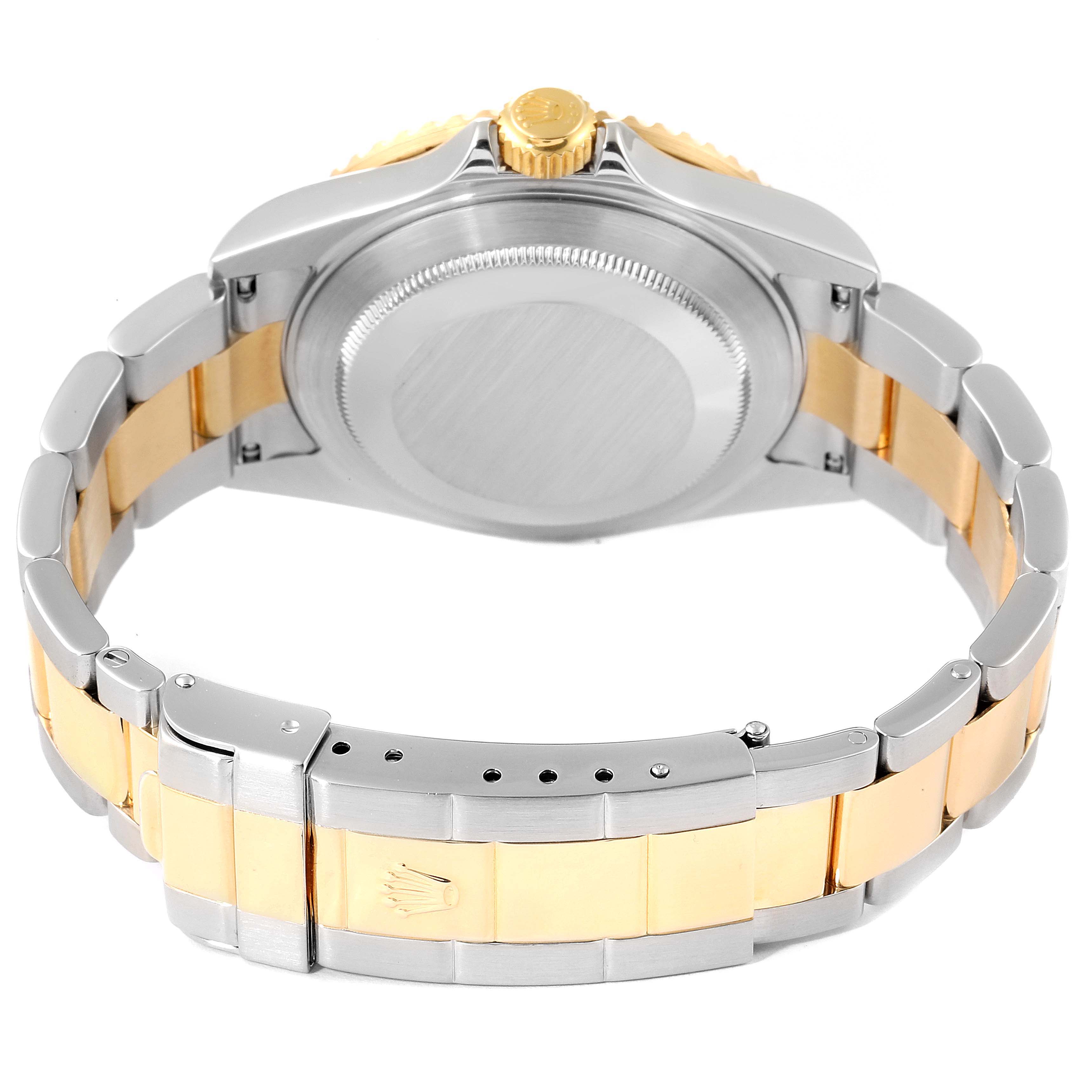 The image shows the case back and bracelet of a Rolex Submariner 16613 Men
s Steel and Gold (two tone) Blue Dial 16613 Men
s Steel and Gold (two tone) Blue Dial, revealing the two-tone steel and gold construction.