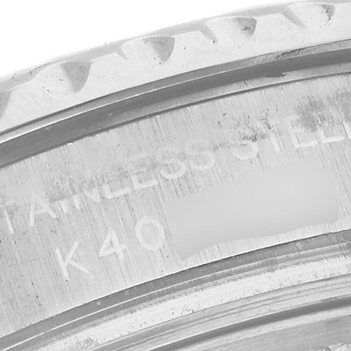 This close-up image of a Rolex Yacht-Master 169622 Women
s Stainless Steel Silver Dial 169622 Women
s Stainless Steel Silver Dial watch shows part of the stainless steel case with some engraved markings.