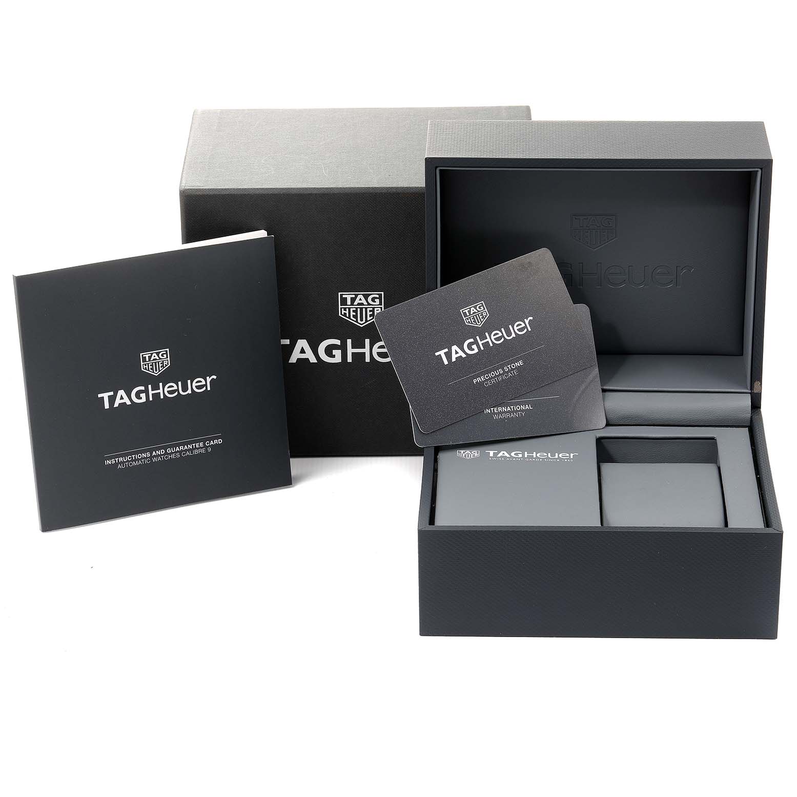 The image shows packaging and accessories for a Tag Heuer Carrera WAR2453.BD0777 Women's Steel and Gold (two tone) Mother of Pearl Dial WAR2453.BD0777 Women's Steel and Gold (two tone) Mother of Pearl Dial model watch, including the box, instruction manual, and warranty card.