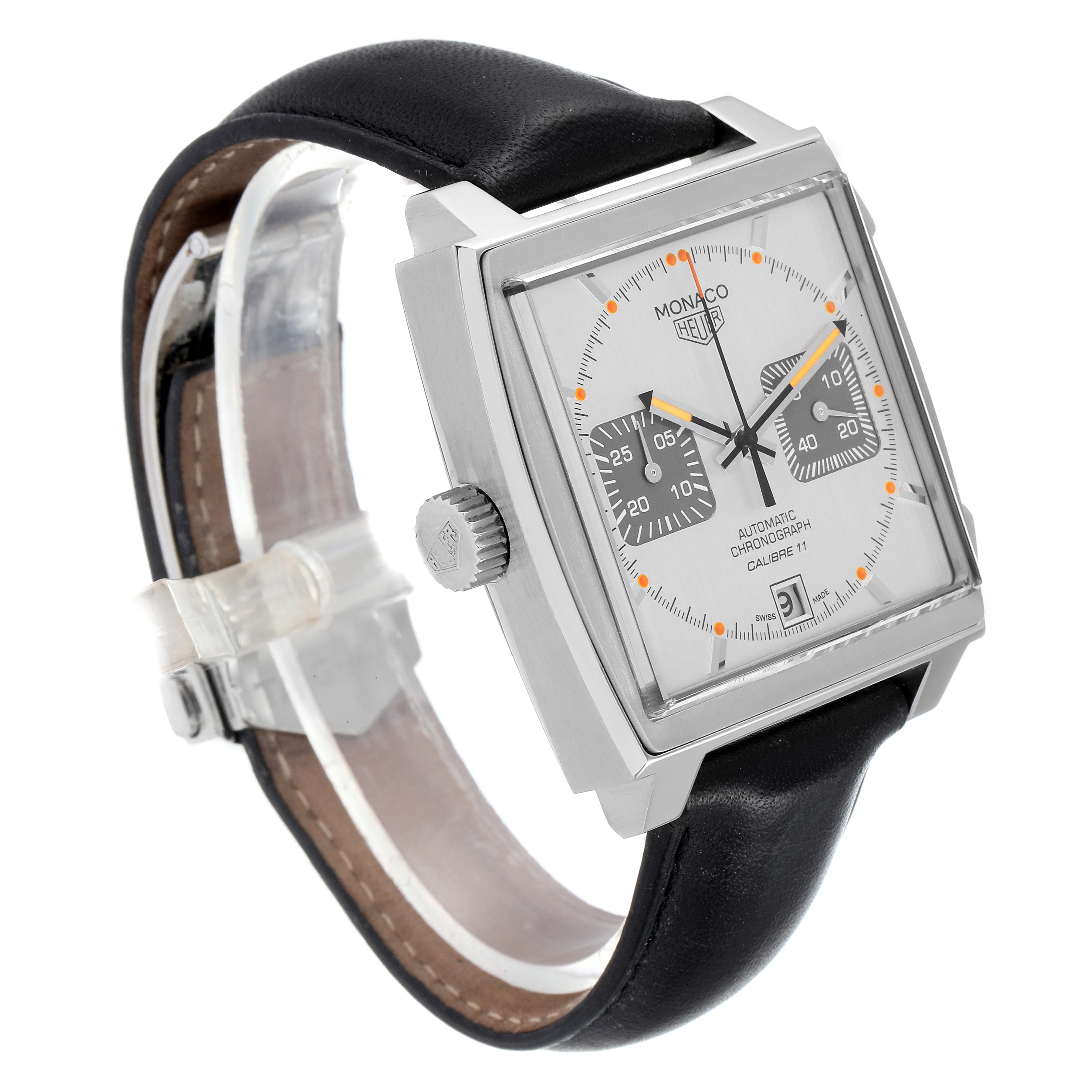 The image shows a side angle of a Tag Heuer Monaco watch, featuring its square face, crown, and black leather strap.