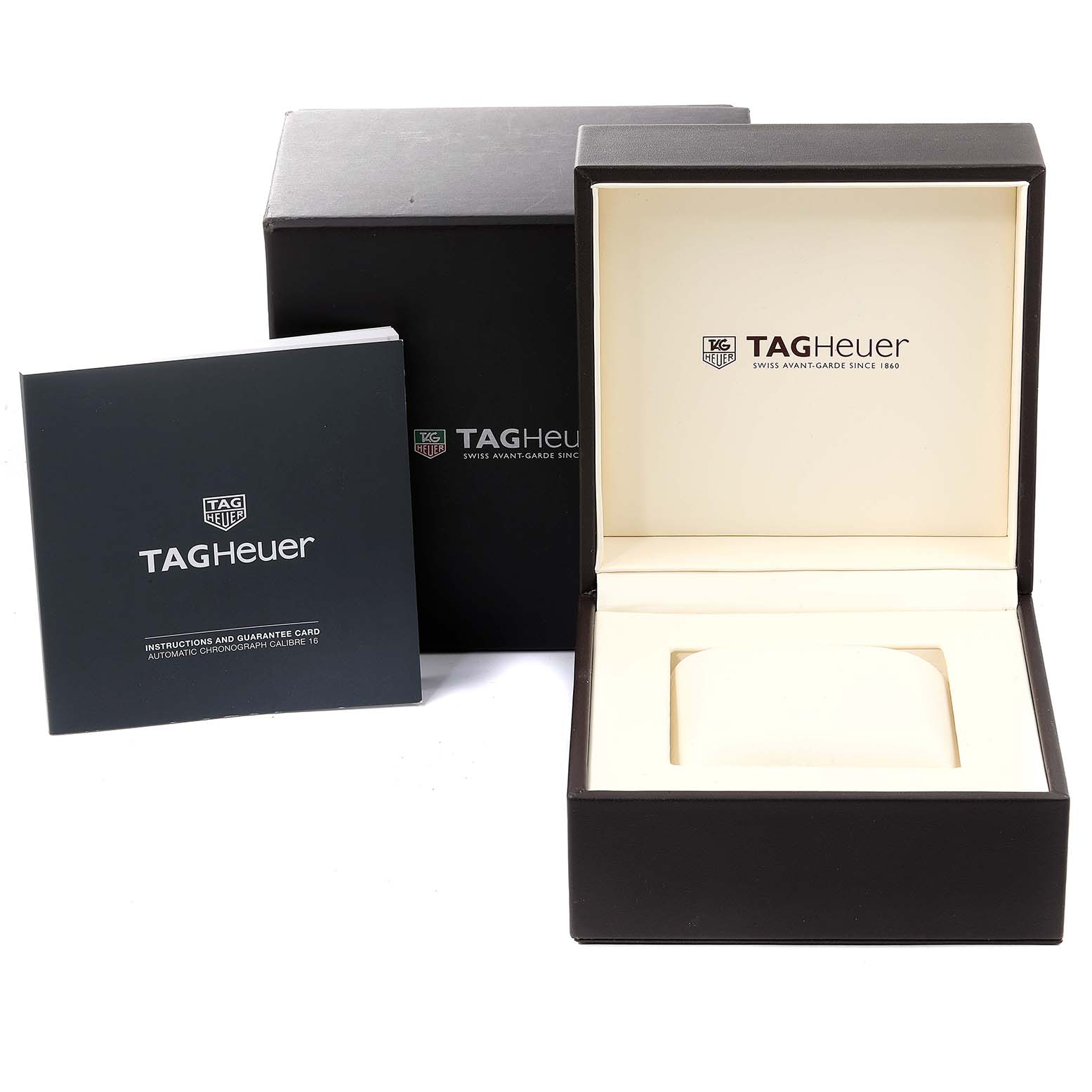 The image shows the packaging, instruction manual, and display case for the Tag Heuer Monaco watch.