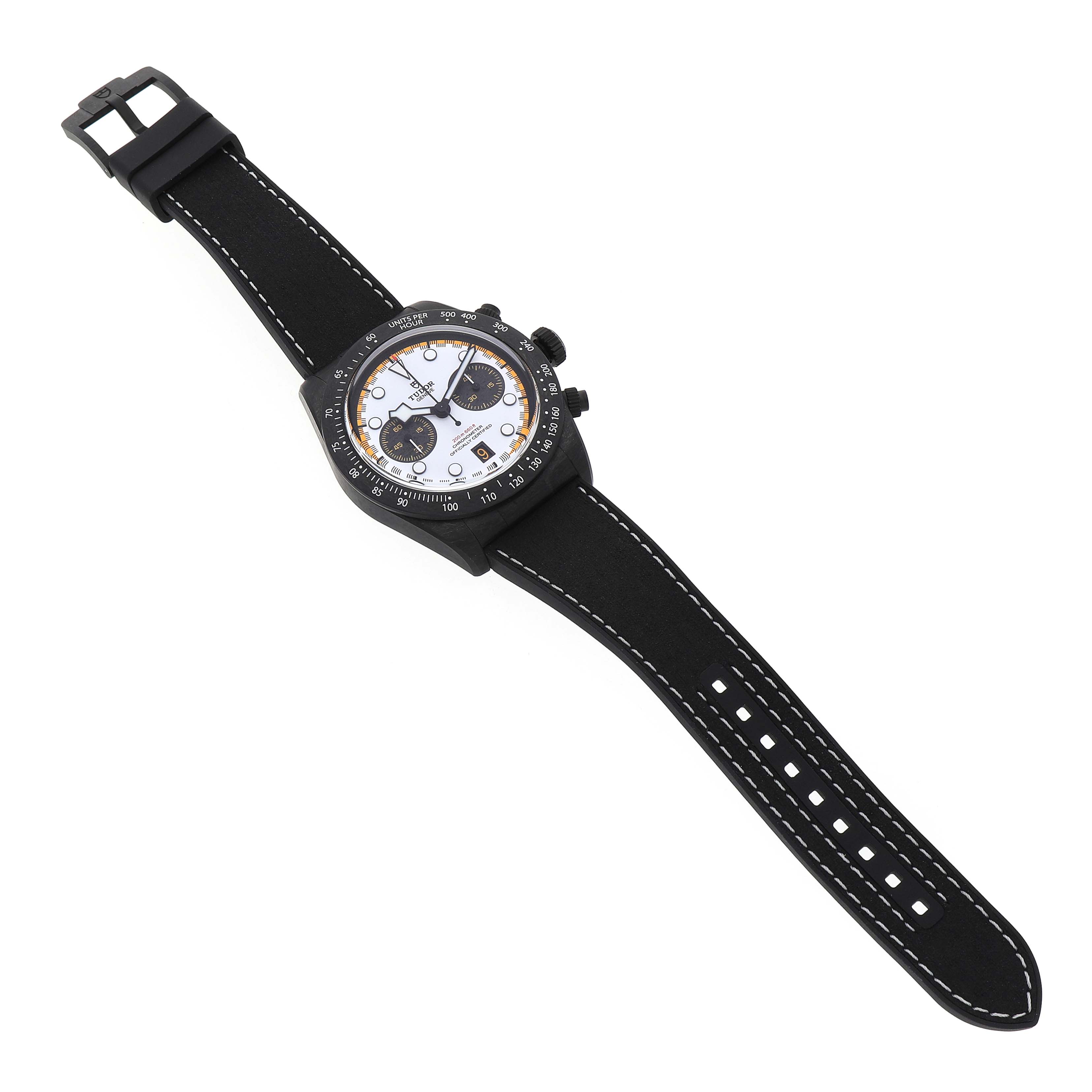 The Tudor Heritage Black Bay 79377KN Men's Titanium White Dial watch is shown from a top-down angle, displaying its face, bezel, and black strap with white stitching.