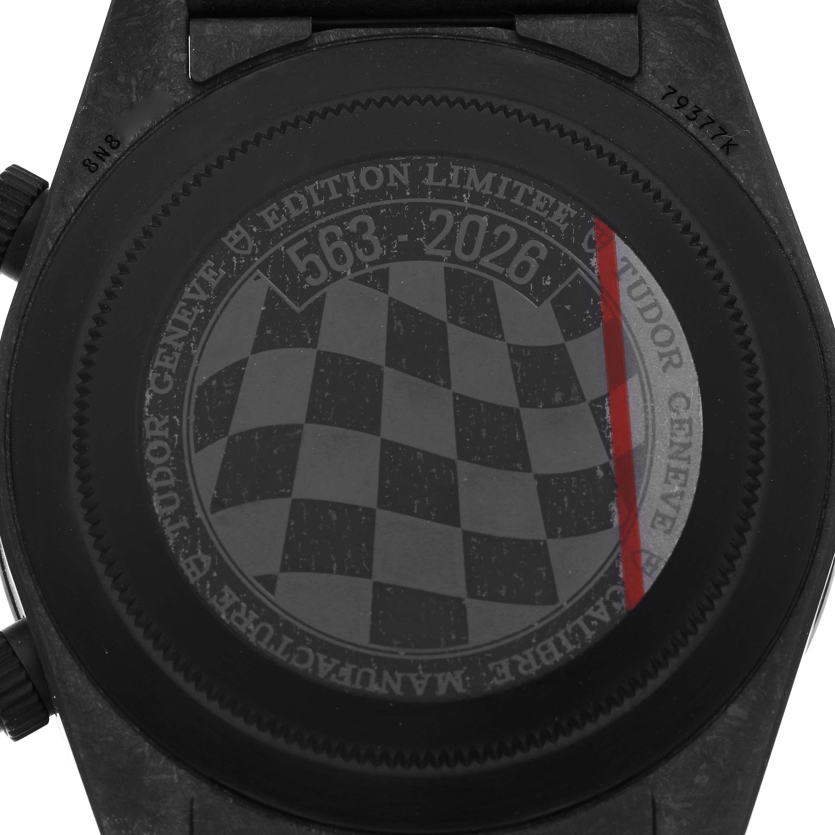 The image shows the back of the Tudor Heritage Black Bay 79377KN Men's Titanium White Dial watch, featuring engraved details and a checkered pattern.
