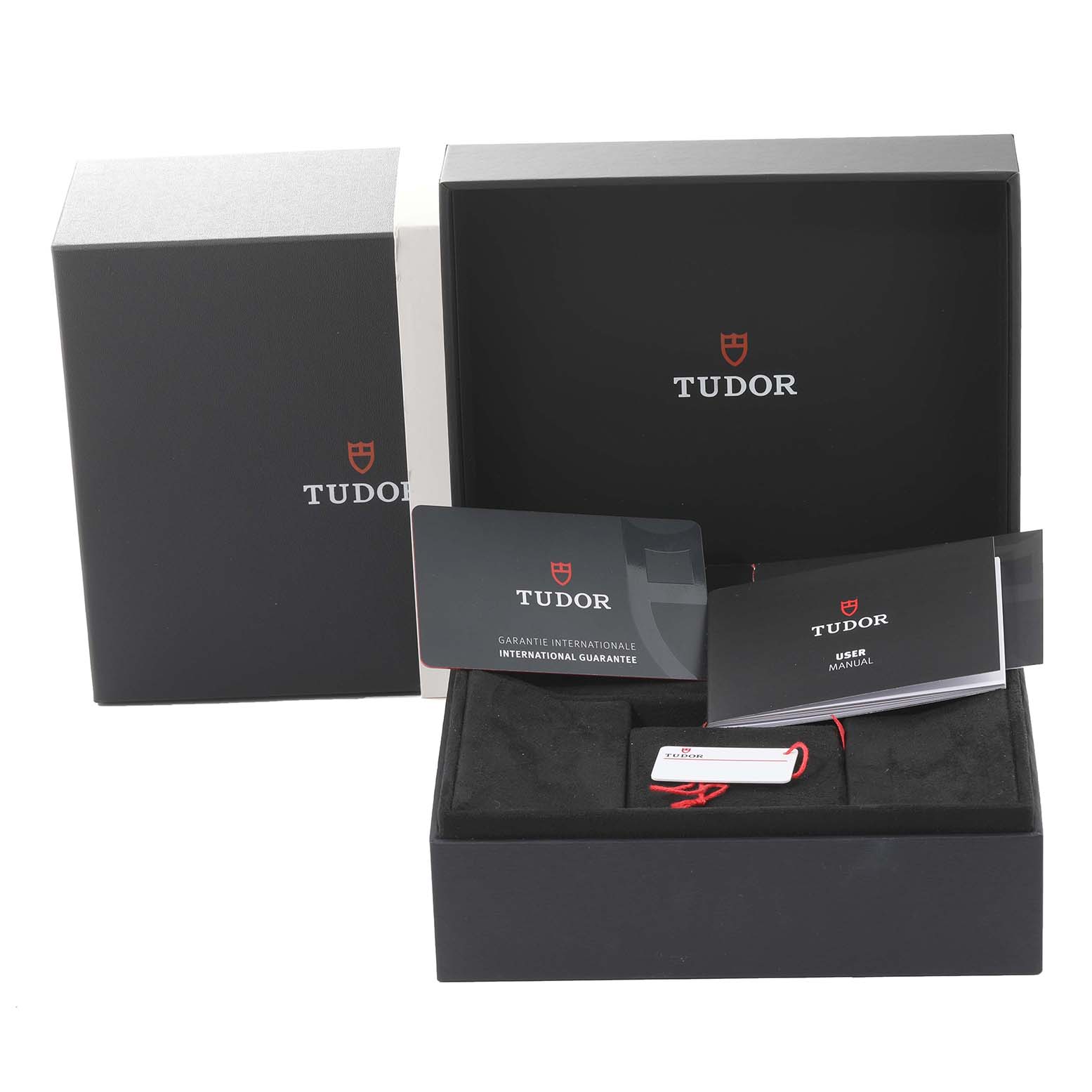 The image shows the packaging, manuals, guarantee card, and tag for the Tudor Heritage Black Bay 79030N Men's Stainless Steel Black Dial 79030N Men's Stainless Steel Black Dial watch.