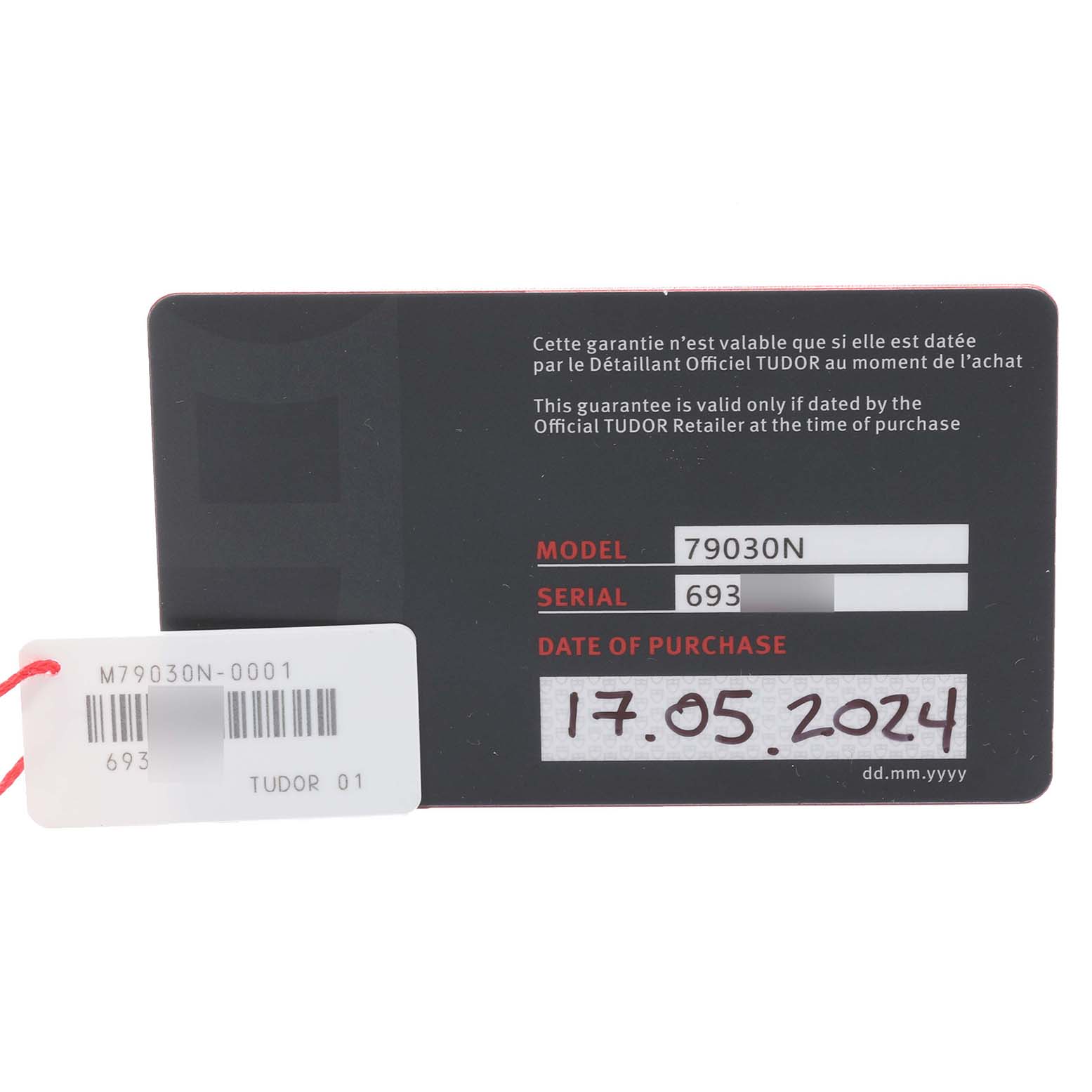 The image shows a warranty card for the Tudor Heritage Black Bay 79030N Men's Stainless Steel Black Dial 79030N Men's Stainless Steel Black Dial model 79030N, featuring the serial number and date of purchase.