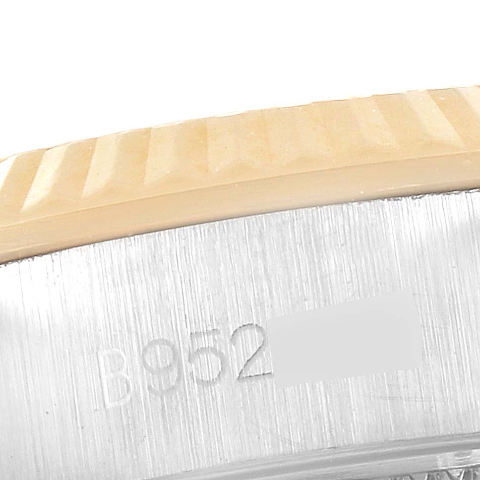 This close-up image shows the edge and part of the case with a serial number engraving of the Tudor Princess 92513 Women's Steel and Gold (two tone) Silver Dial 92513 Women's Steel and Gold (two tone) Silver Dial model watch.