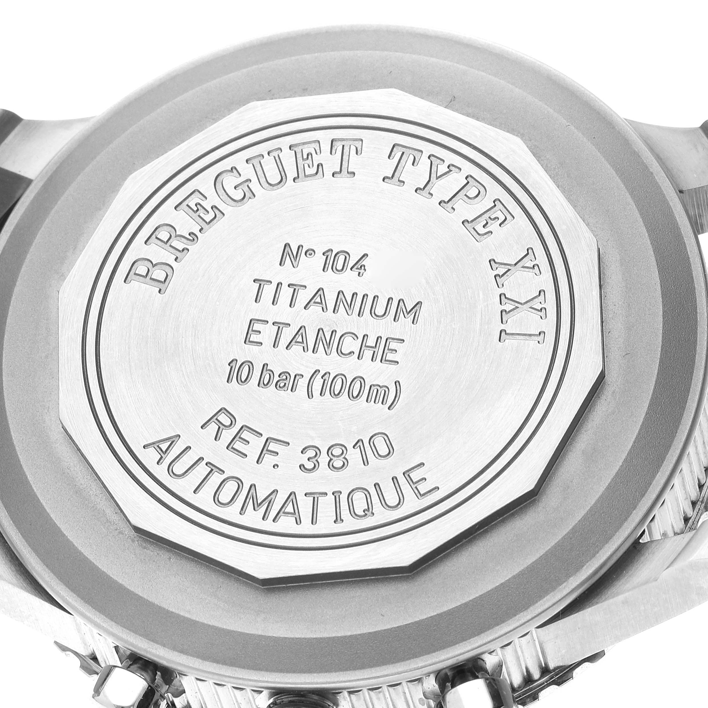 The image shows the case back of a Breguet Type XXI watch, featuring inscriptions about the model and specifications.