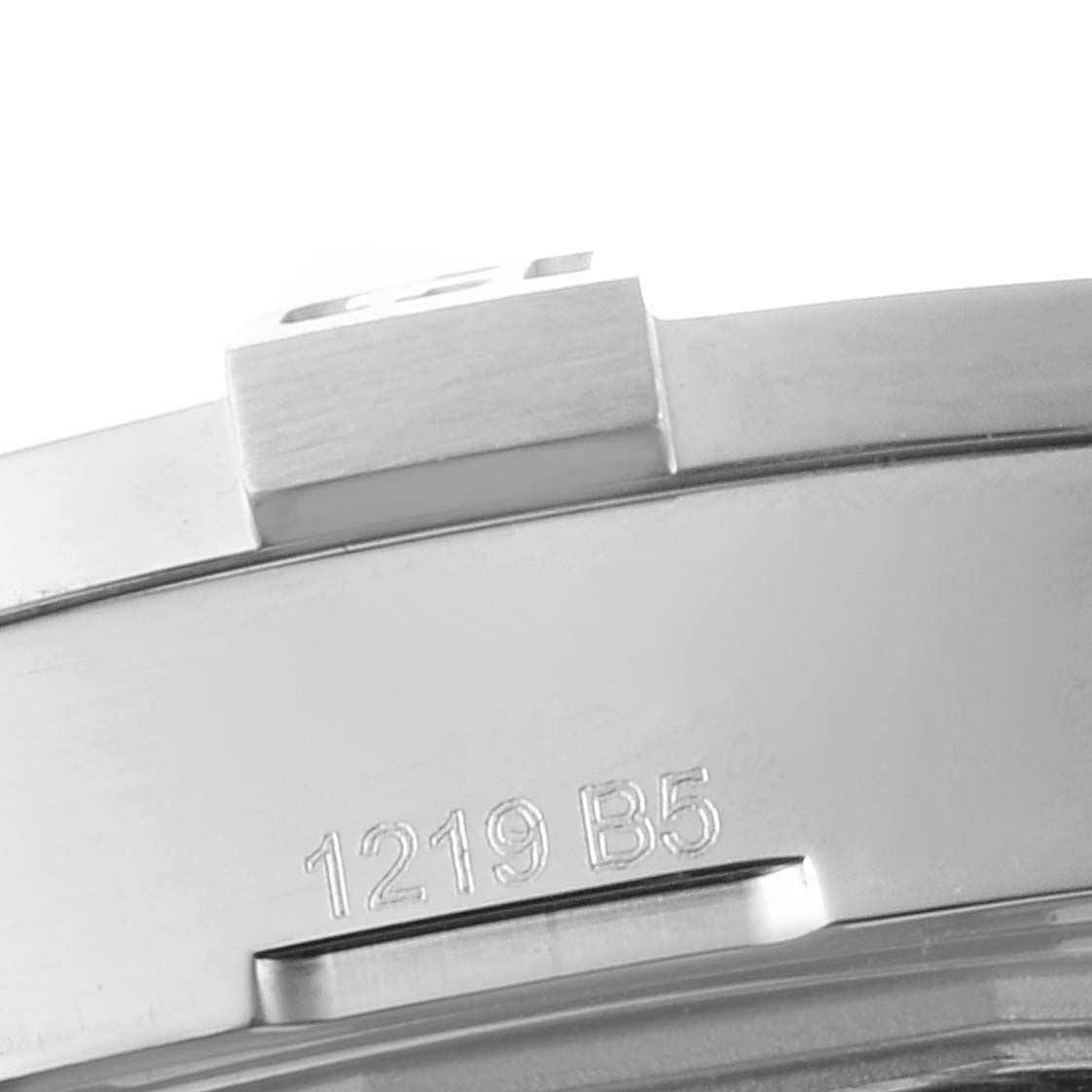 This close-up image shows the side of the bezel and part of the casing of a Breitling Avenger A3239011-C872-170A Men
s Stainless Steel Mother of Pearl Dial A3239011-C872-170A Men
s Stainless Steel Mother of Pearl Dial watch with the engraved numbers "1219 B5."