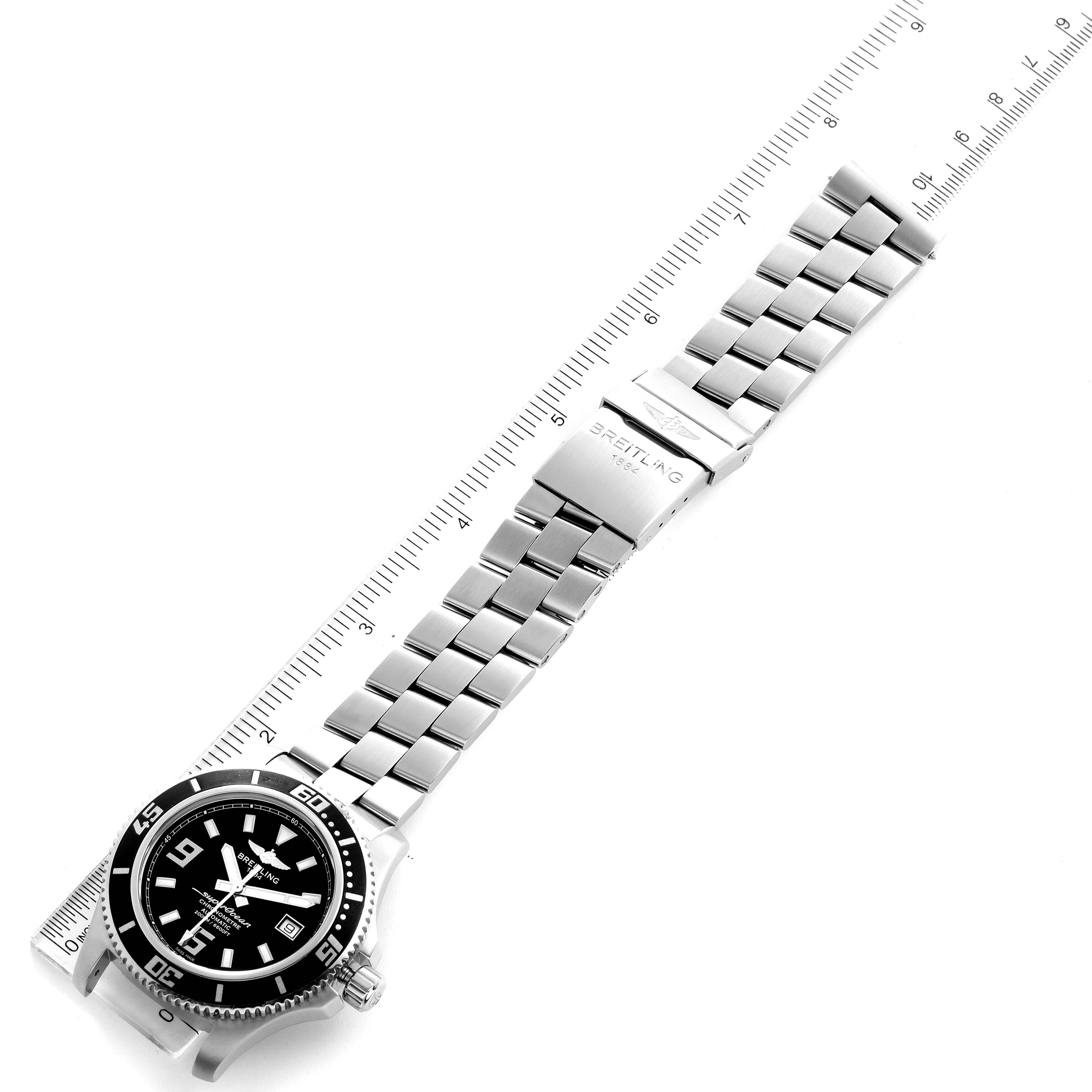 The image shows a top view of the Breitling Superocean A17391 Men's Stainless Steel Black Dial A17391 Men's Stainless Steel Black Dial watch, focusing on the face, bezel, and metal bracelet with a ruler for scale.