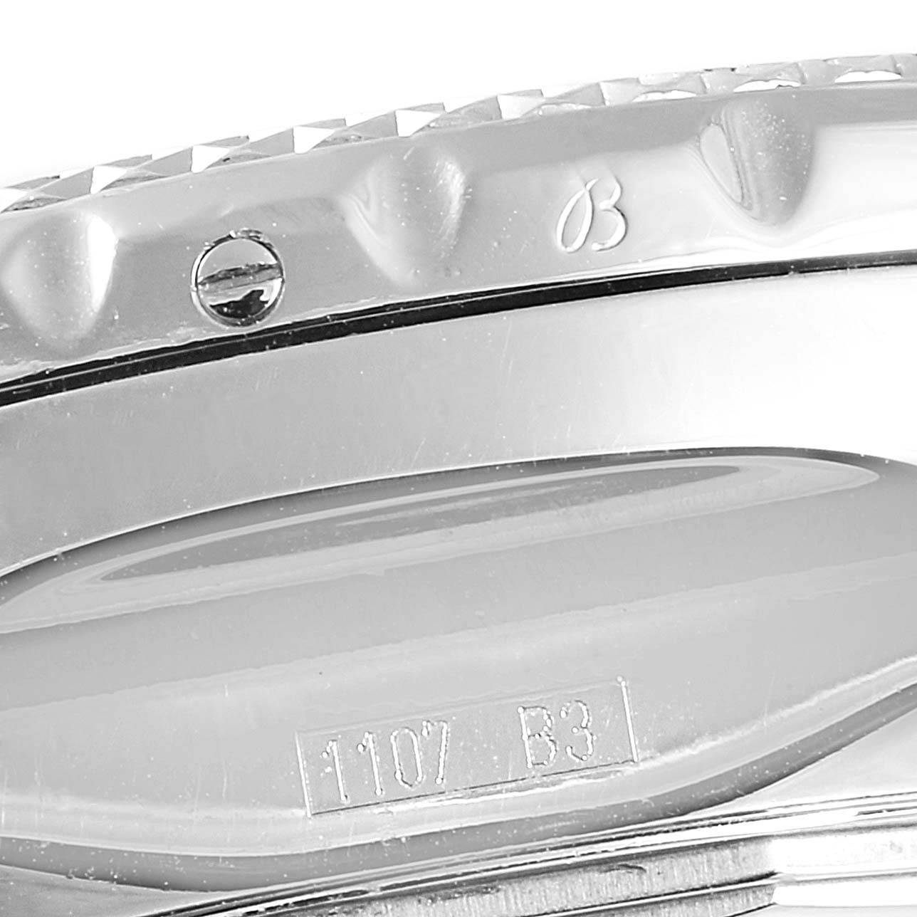 The image shows a close-up view of the bezel and side of the Bentley model by Breitling watch, highlighting details like the engraved 'B' and serial number.