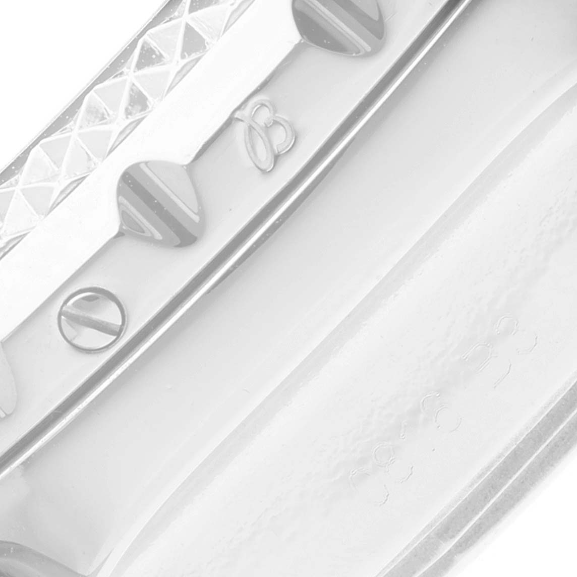 The image shows a close-up of the Bentley model by Breitling, focusing on the textured bezel and screws.