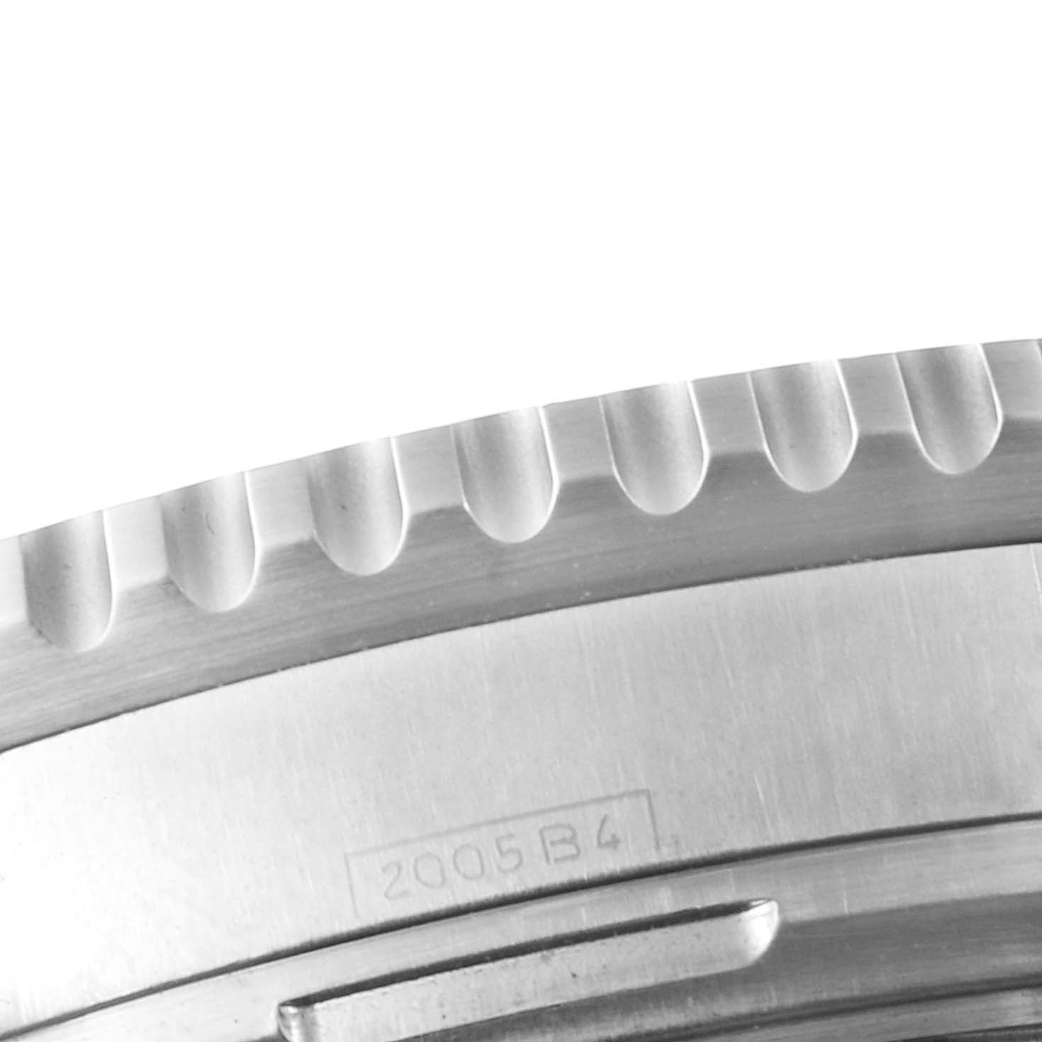 The image shows a close-up of the knurled bezel and part of the case back of the Breitling Navitimer A23330 Men's Stainless Steel Silver Dial A23330 Men's Stainless Steel Silver Dial watch.