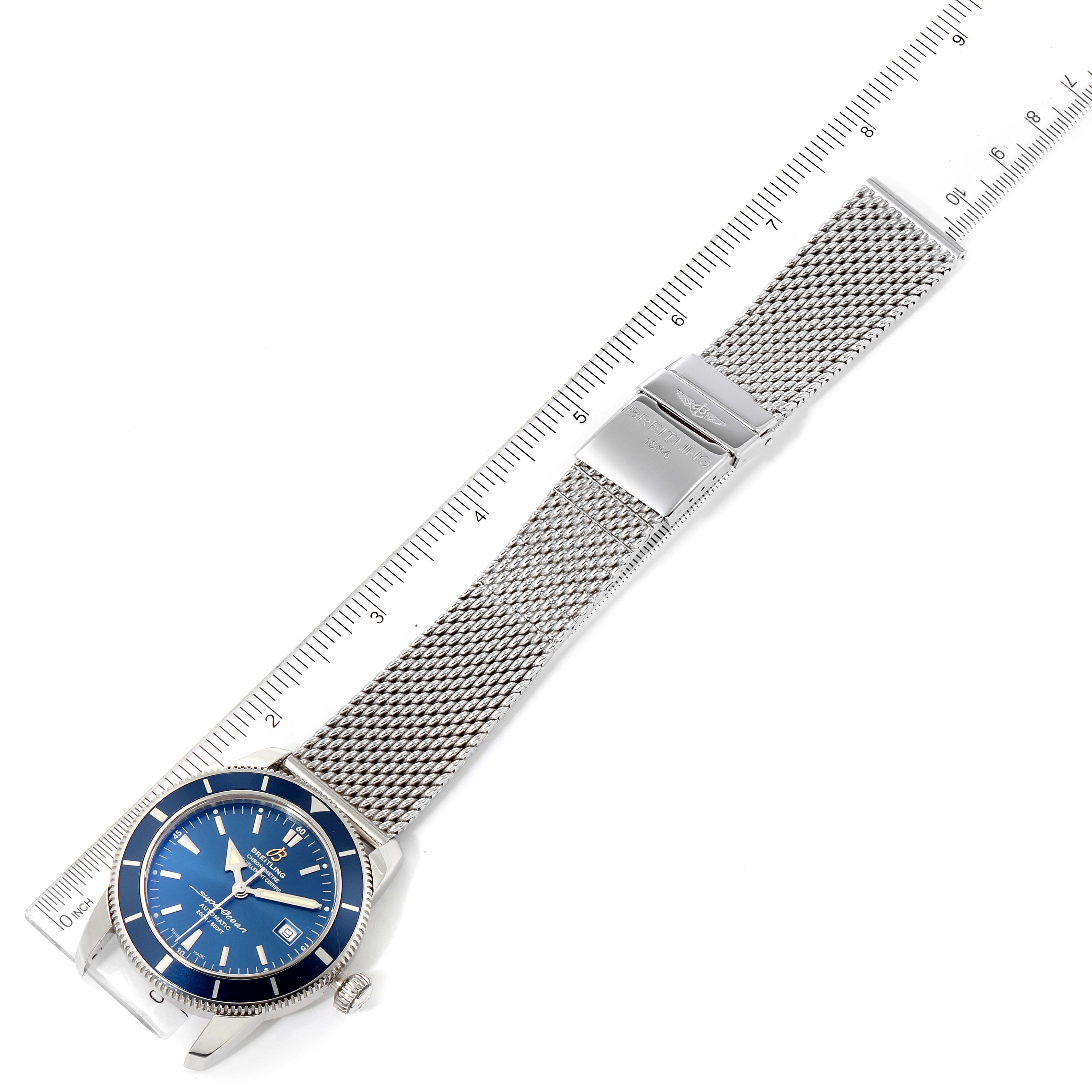 The image shows a top-down view of a Breitling Superocean A17321 Men
s Stainless Steel Blue Dial A17321 Men
s Stainless Steel Blue Dial watch, highlighting its blue dial and stainless steel mesh bracelet.