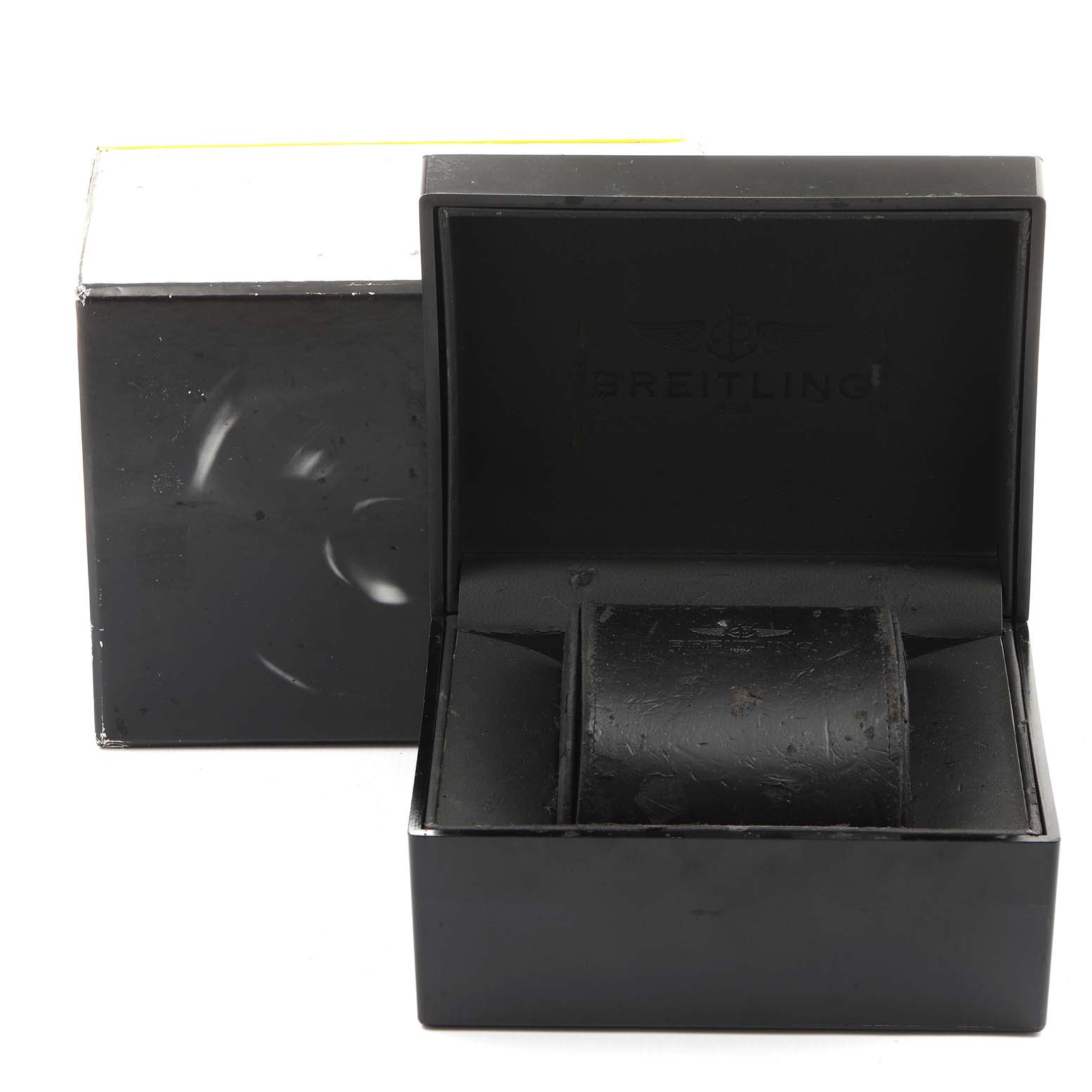 This image shows the opened black watch box and pillow of a Breitling Superocean A17321 Men
s Stainless Steel Blue Dial A17321 Men
s Stainless Steel Blue Dial, with another box in the background.