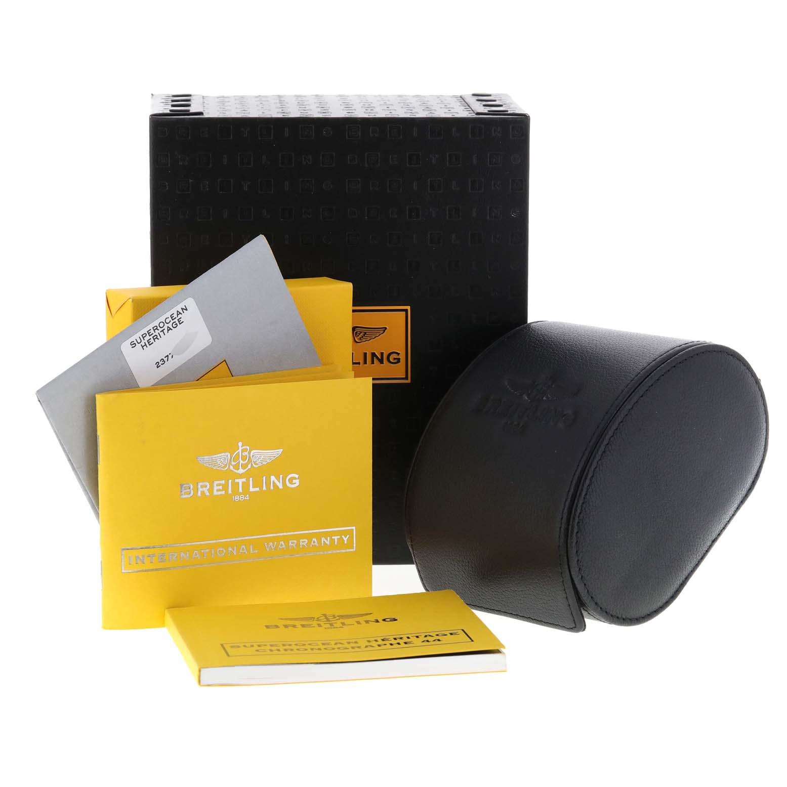 The image shows a Breitling Superocean A23370 Men's Stainless Steel Blue Dial A23370 Men's Stainless Steel Blue Dial watch box, international warranty card, manuals, and a leather watch case.