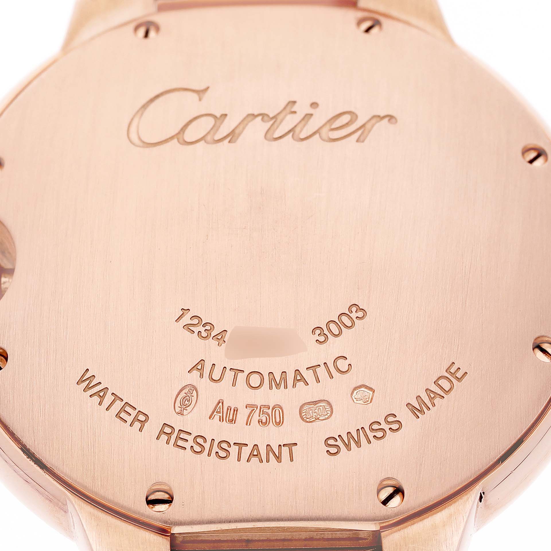The image shows the case back of a Cartier Ballon Bleu WE9005Z3 Women's Rose Gold Silver Dial watch, highlighting the engraving and material details.