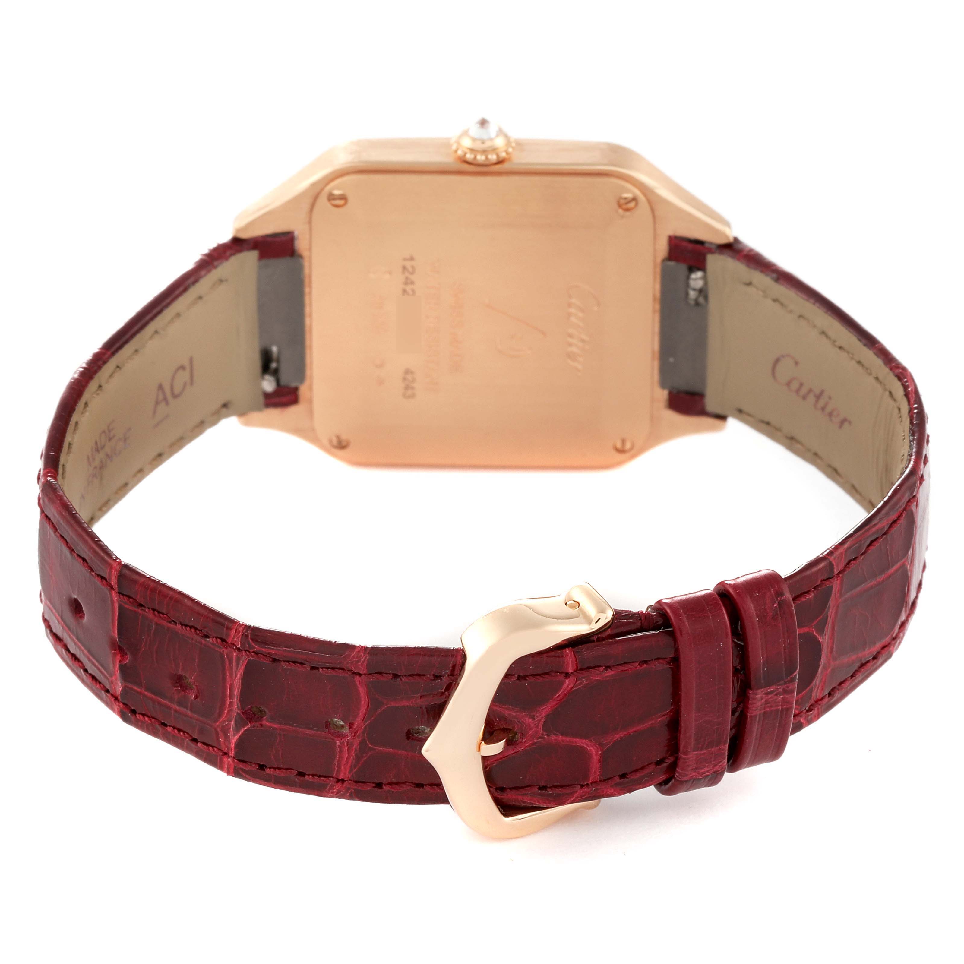 This image shows the back case and strap of a Cartier Santos WJSA0017 Women
s Rose Gold Silver Dial WJSA0017 Women
s Rose Gold Silver Dial Dumont watch, with a red leather band and metal clasp.