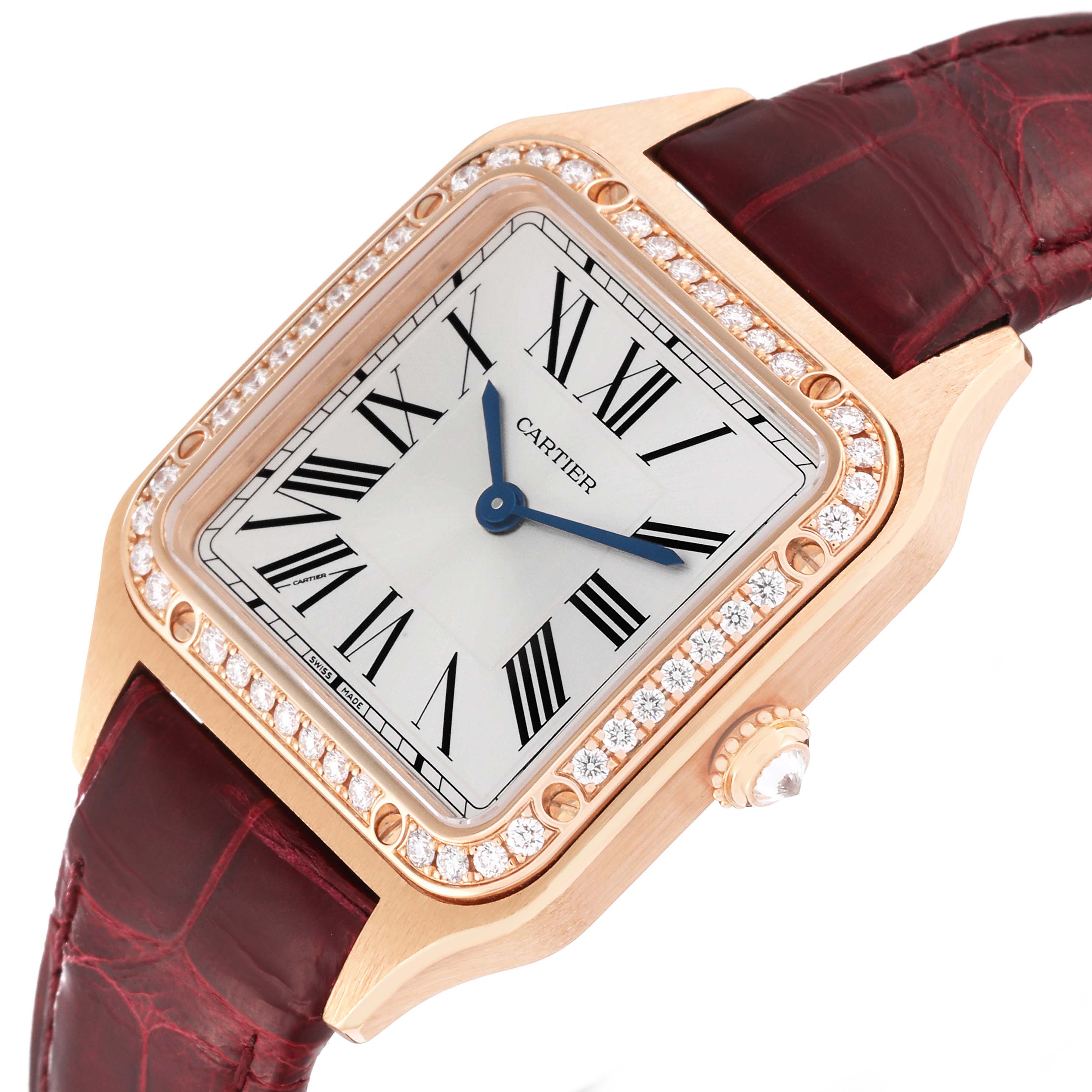 The Cartier Santos WJSA0017 Women's Rose Gold Silver Dial watch is shown at an angled overhead view, displaying its diamond-studded bezel, dial with Roman numerals, and leather strap.