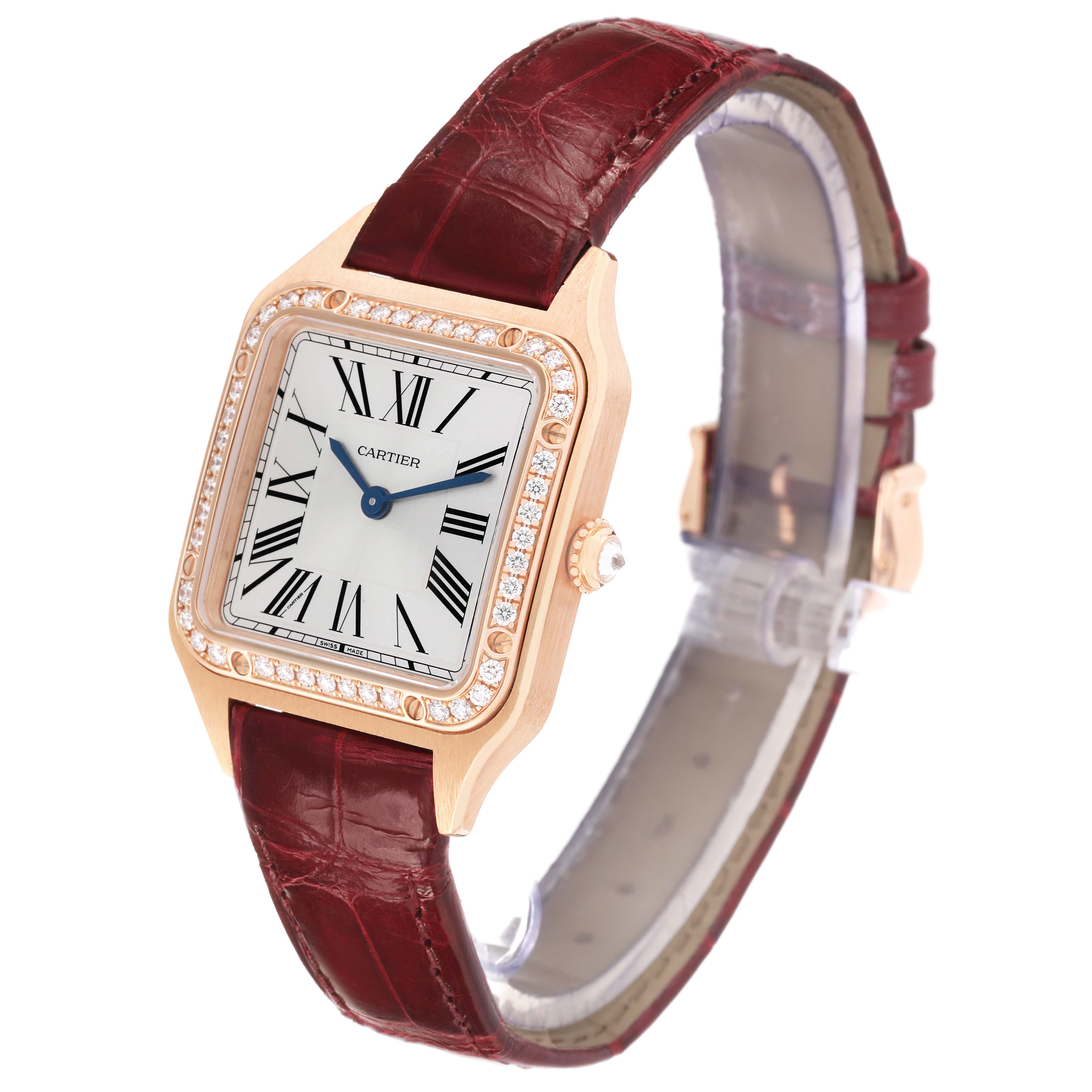 The Cartier Santos WJSA0017 Women's Rose Gold Silver Dial watch is shown at a three-quarter angle, displaying the square face, bezel with diamonds, crown, and leather strap.