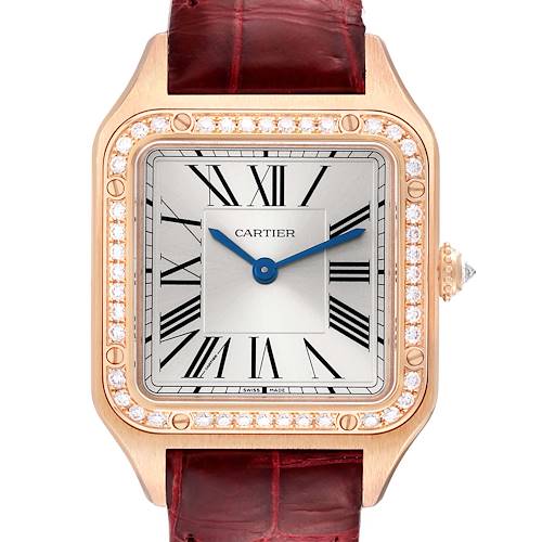 The Cartier Santos WJSA0017 Women's Rose Gold Silver Dial watch is shown from the front, displaying its square face, Roman numerals, diamond-studded bezel, and red leather strap.