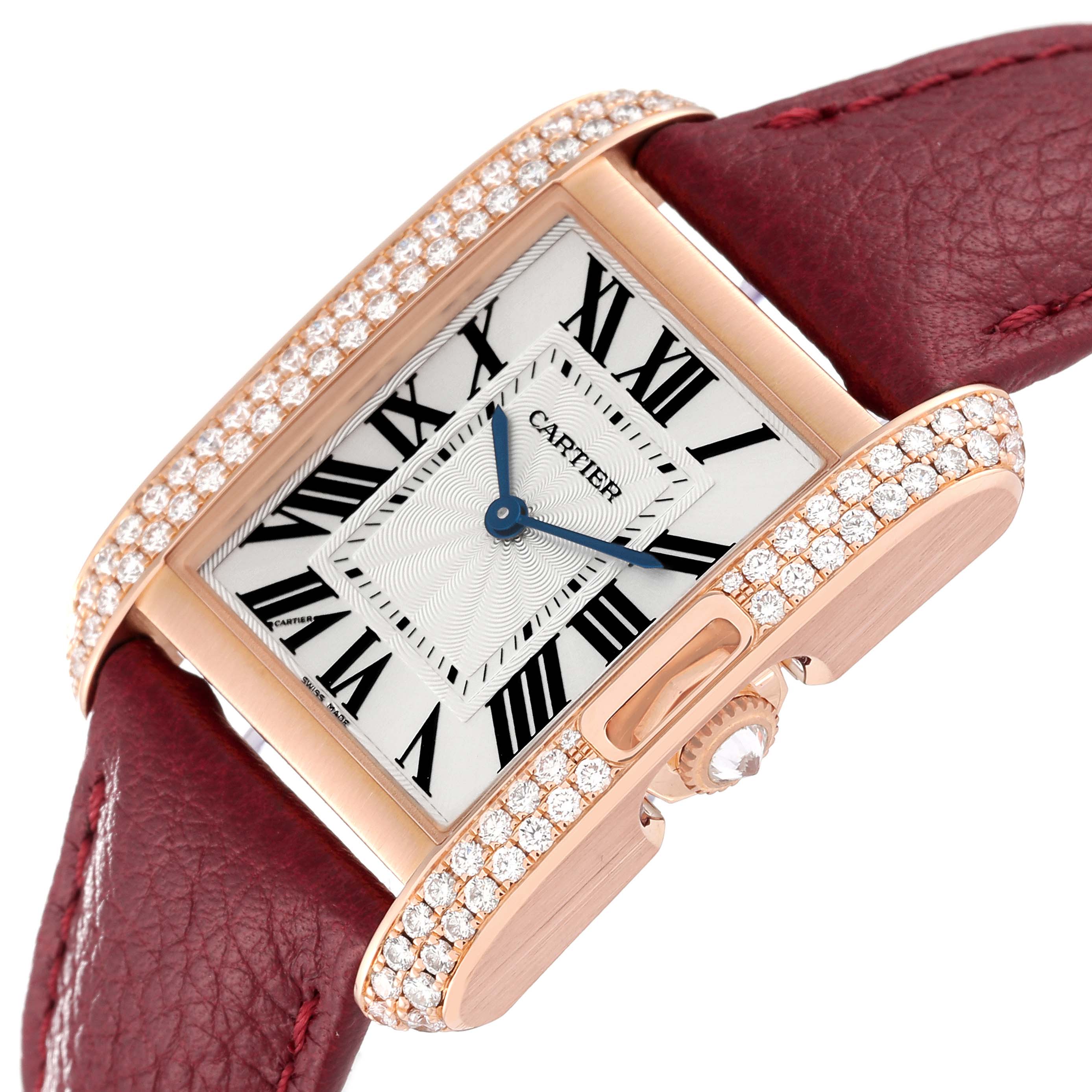 The image shows a close-up angled view of the Cartier Tank Anglaise WT100029 Women
s Rose Gold Silver Dial WT100029 Women
s Rose Gold Silver Dial watch, highlighting its face, crown, and diamond-encrusted bezel with a red leather strap.