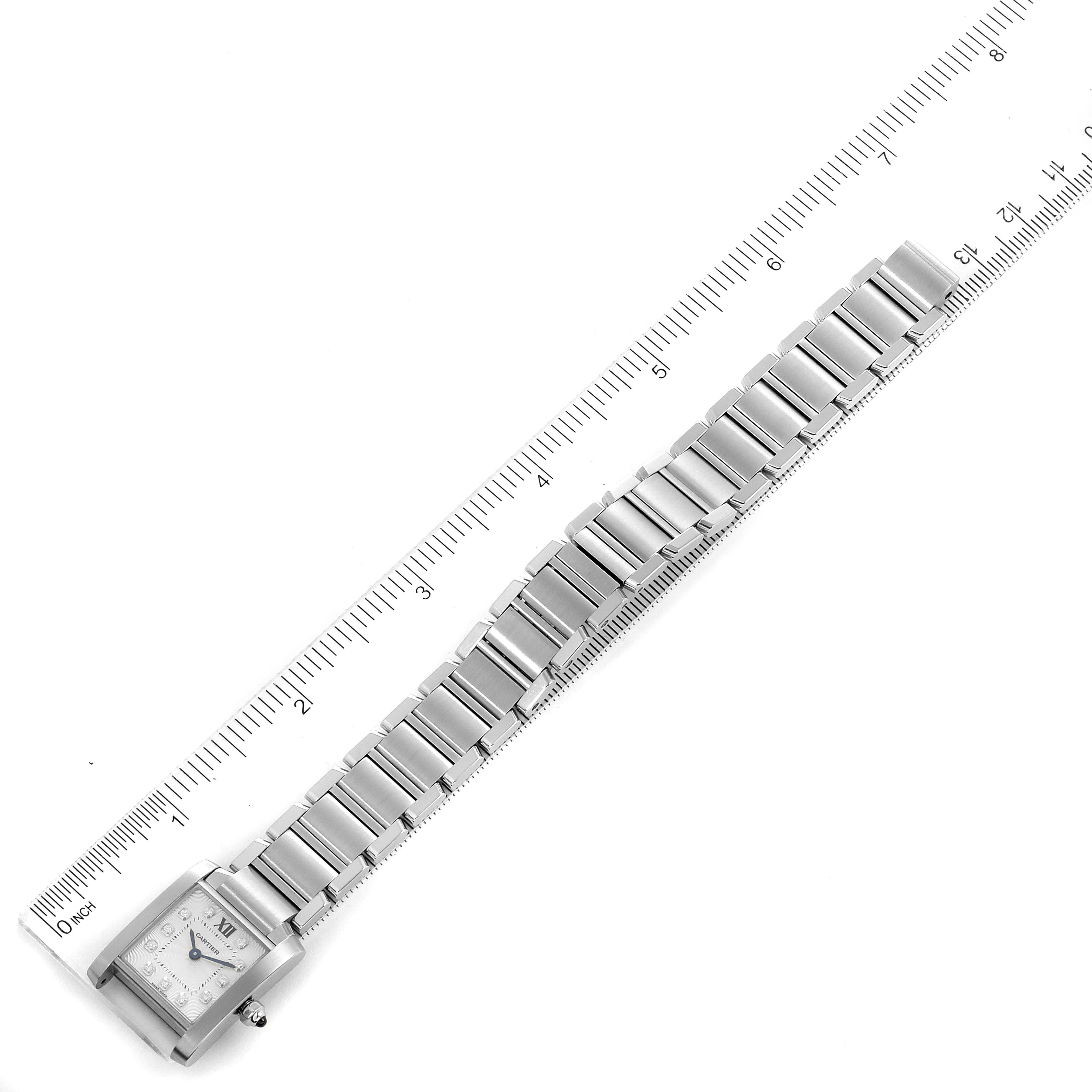 The image shows a top-down view of a Cartier Tank Française watch with a ruler for scale, highlighting the band and face.