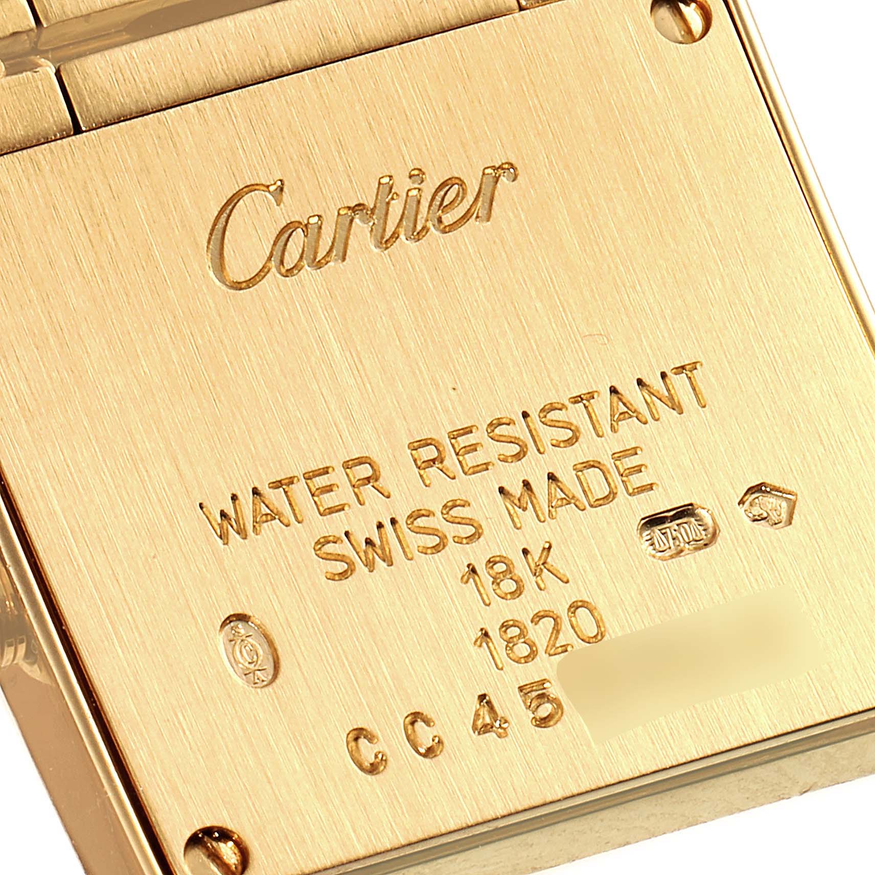 A close-up of the backplate of a Cartier Tank Française watch, displaying engravings and markings.