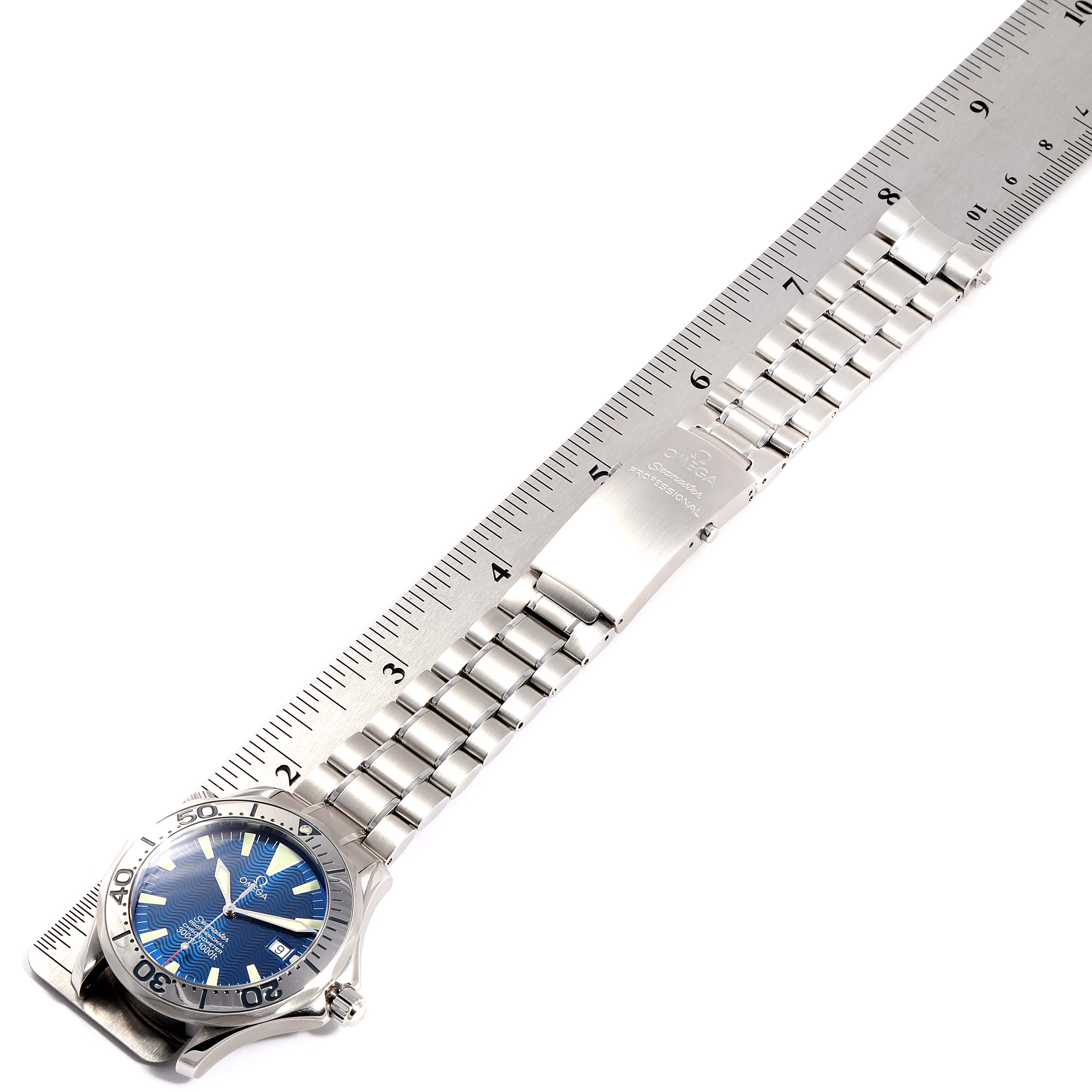 The image shows an Omega Seamaster 2255.80.00 Men's Stainless Steel Blue Dial 2255.80.00 Men's Stainless Steel Blue Dial watch laid flat against a ruler, highlighting its bracelet and clasp.