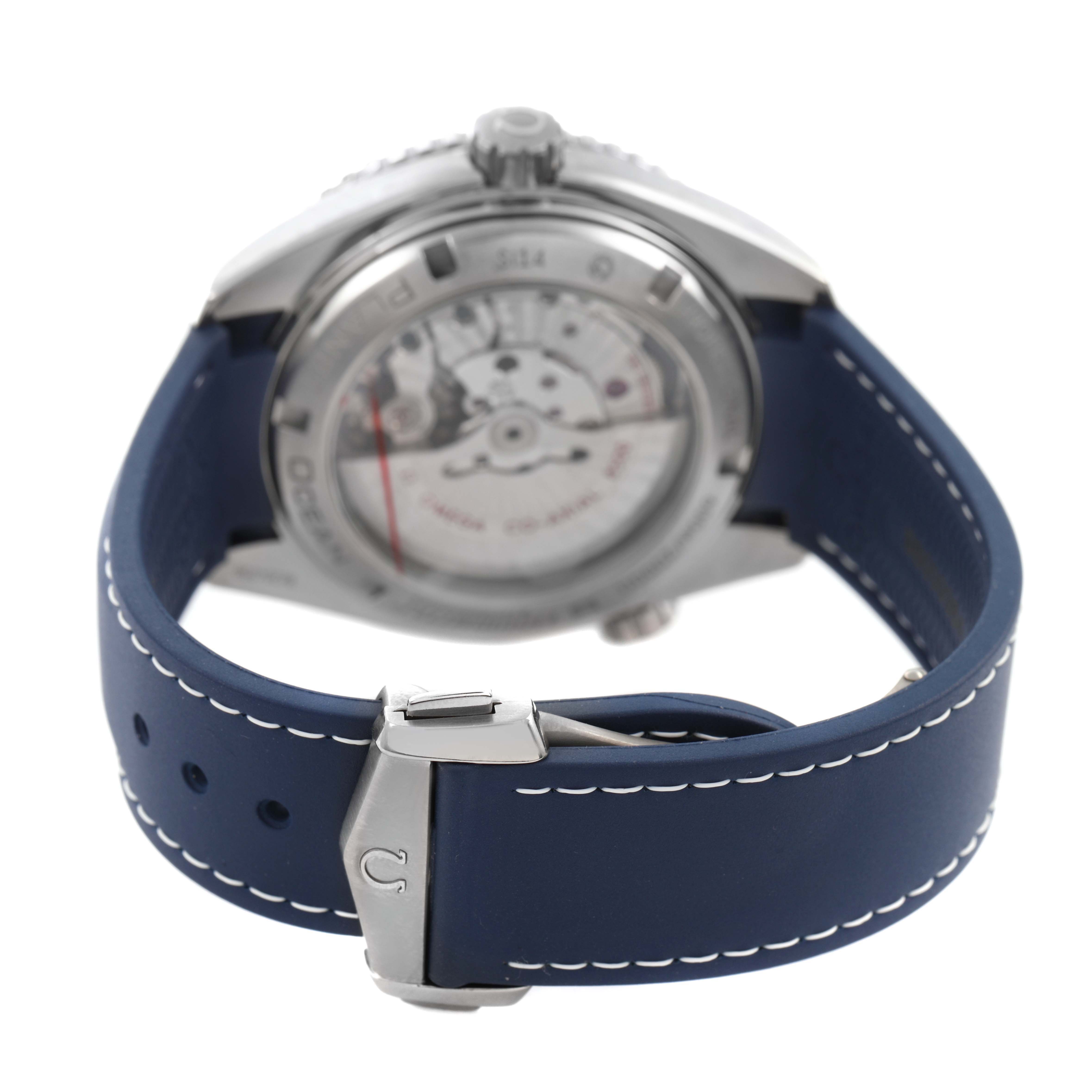 The image shows the back view of an Omega Seamaster 232.92.46.21.03.001 Men's Titanium Blue Dial watch, displaying its movement and blue strap with stitching and clasp.