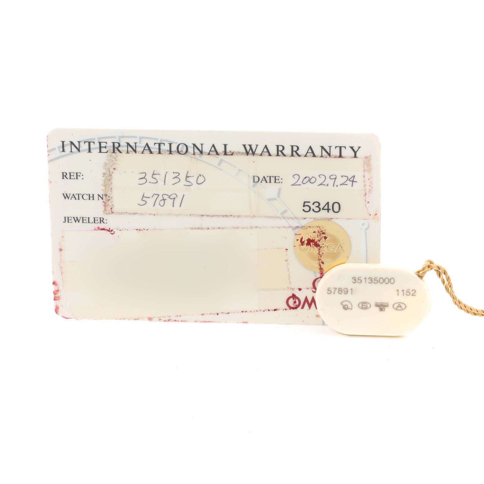 This image shows the international warranty card and tag for an Omega Speedmaster 3513.50.00 Men
s Stainless Steel Black Dial 3513.50.00 Men
s Stainless Steel Black Dial watch, viewed from the front.