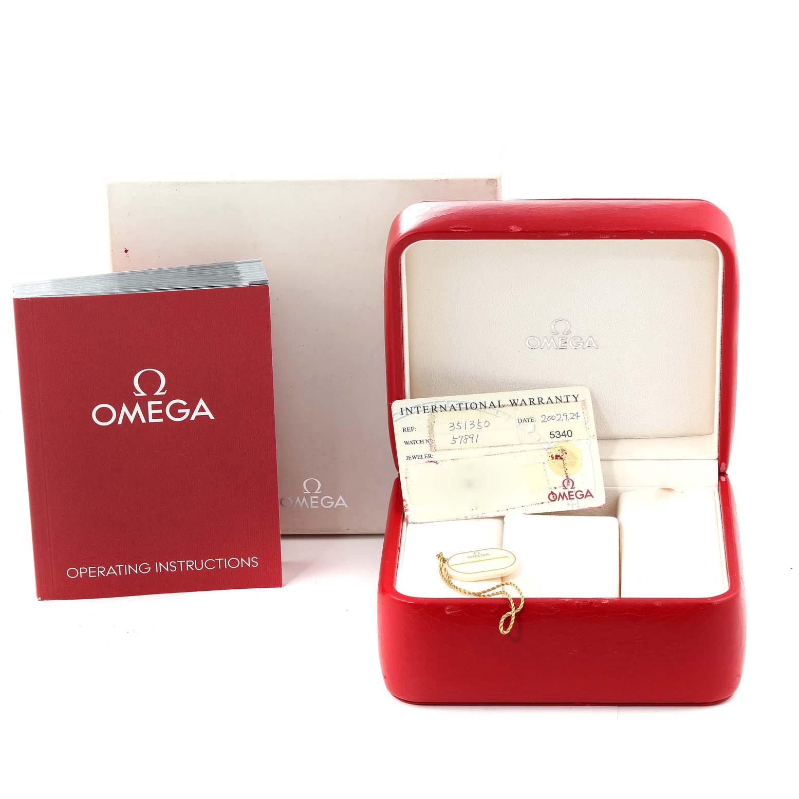 The image shows the accessories for an Omega Speedmaster 3513.50.00 Men
s Stainless Steel Black Dial 3513.50.00 Men
s Stainless Steel Black Dial, including a red watch box, warranty card, and operating instructions.